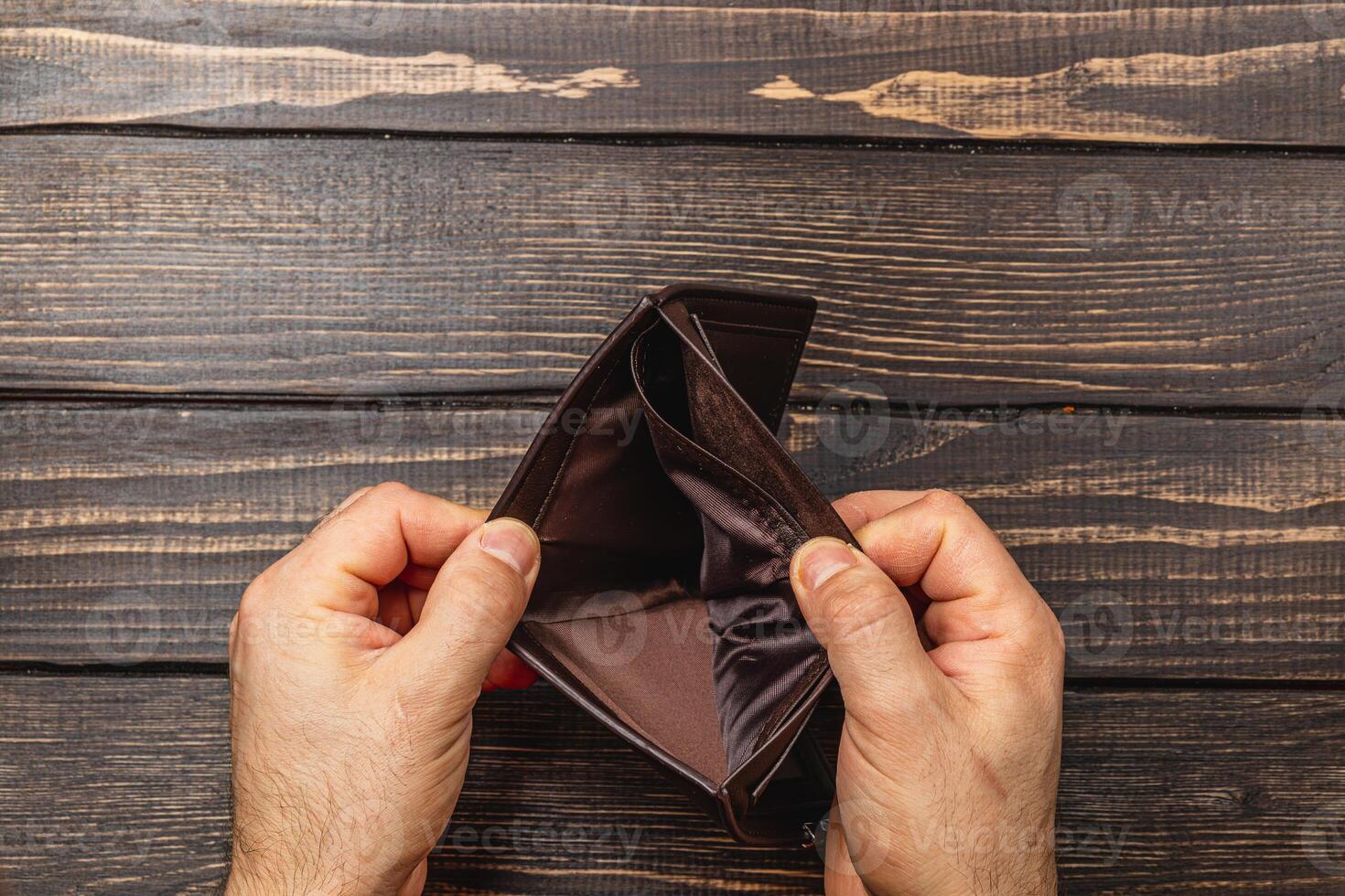 Financial despair leads to an empty wallet reflecting personal crisis photo