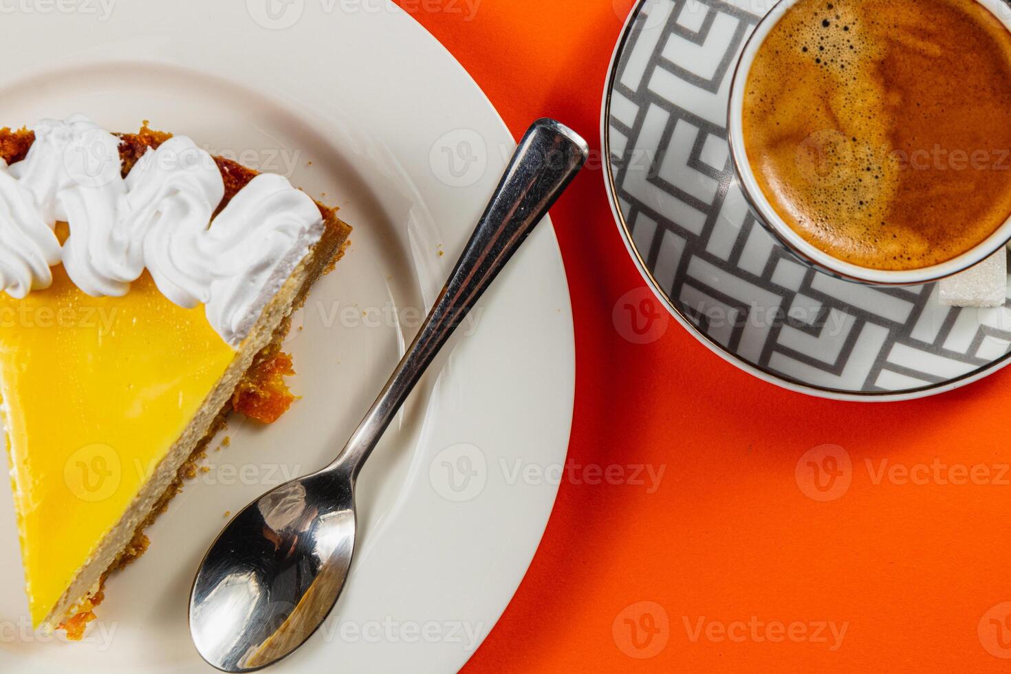 Enjoying a delightful slice of cake alongside a steaming cup of coffee photo