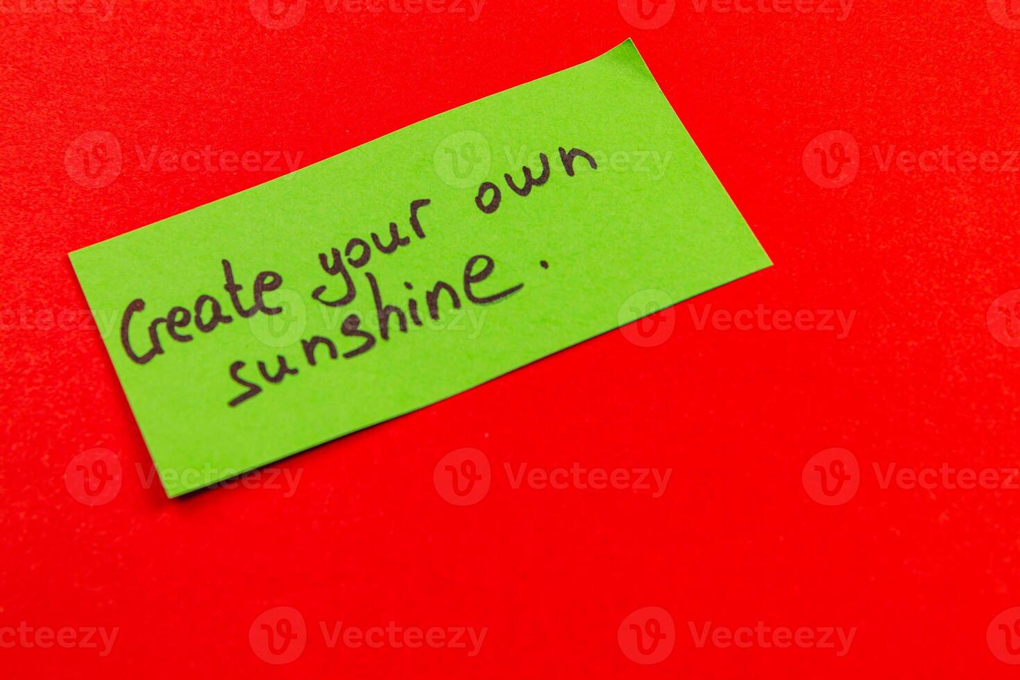 Create your own sunshine message on a bright green note against red background photo