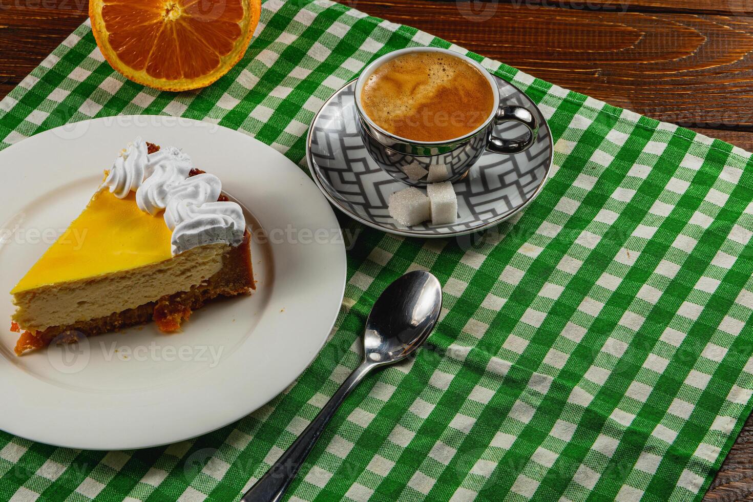 Citrus cheesecake with espresso on a cozy table setting photo
