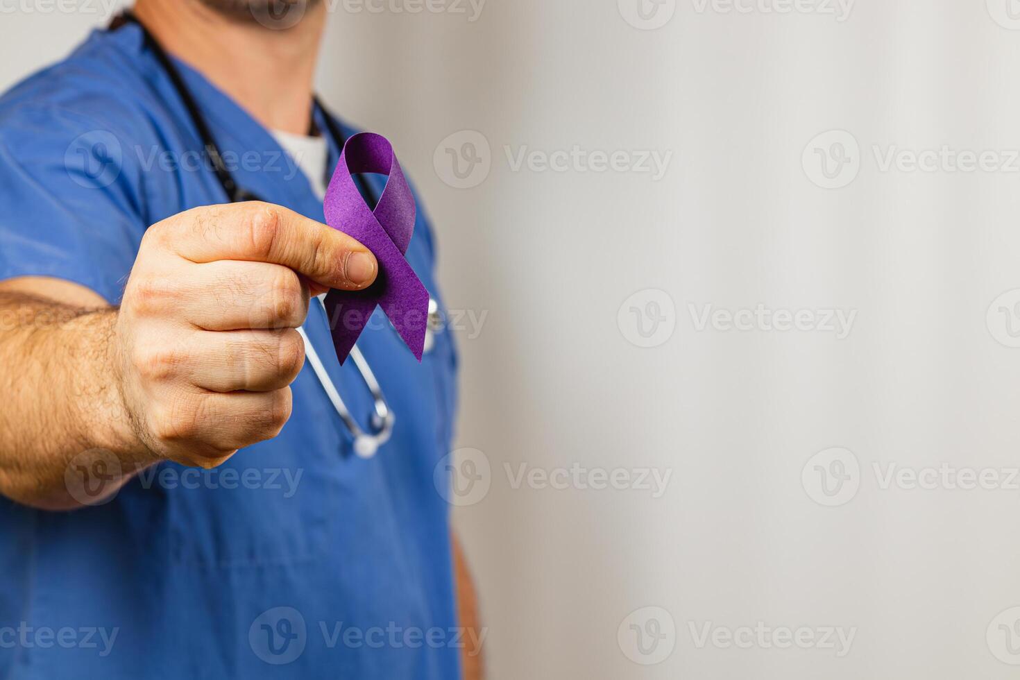 Healthcare worker showing purple ribbon for awareness campaign in hospital photo