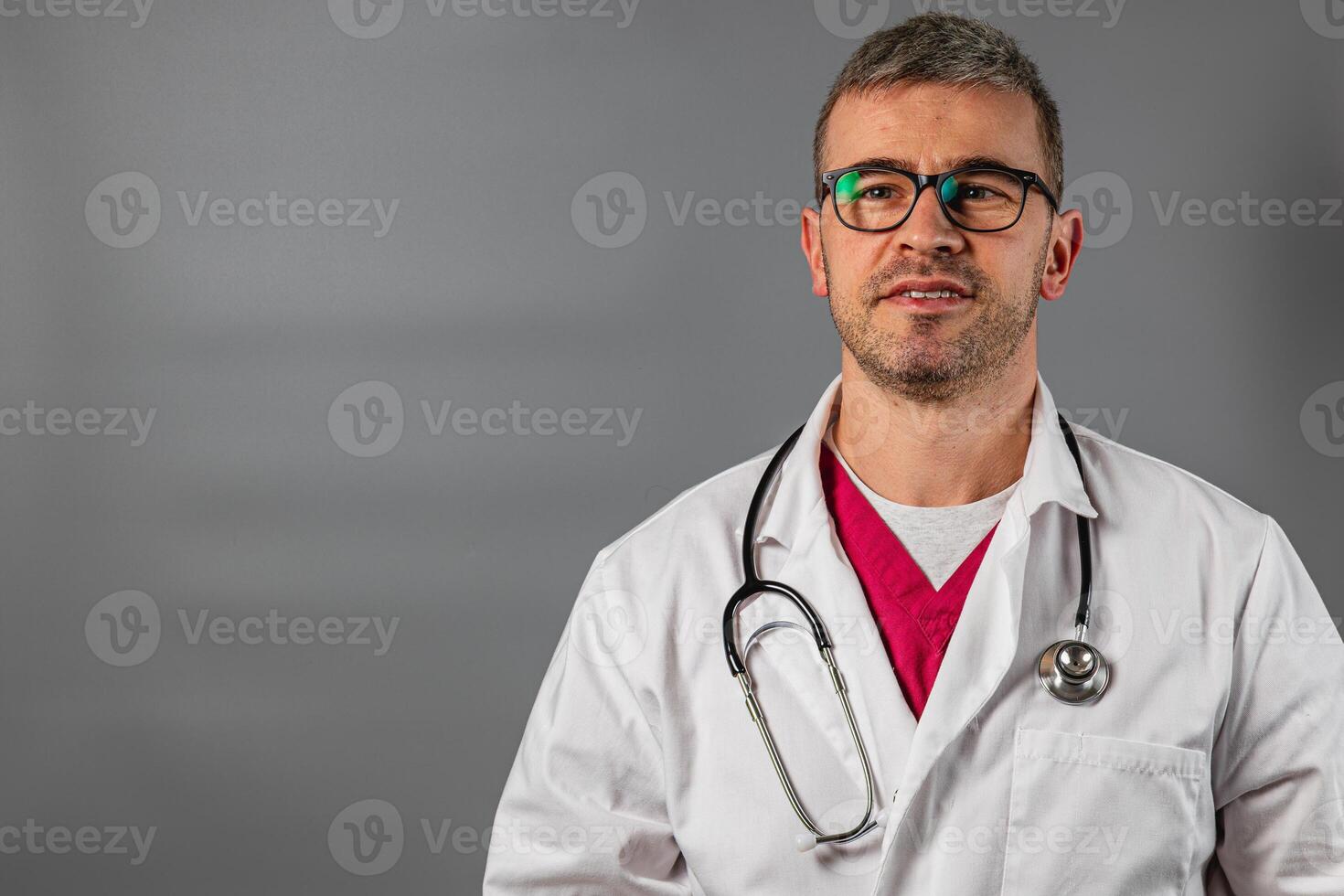 Medical professional in lab coat with stethoscope in modern setting photo