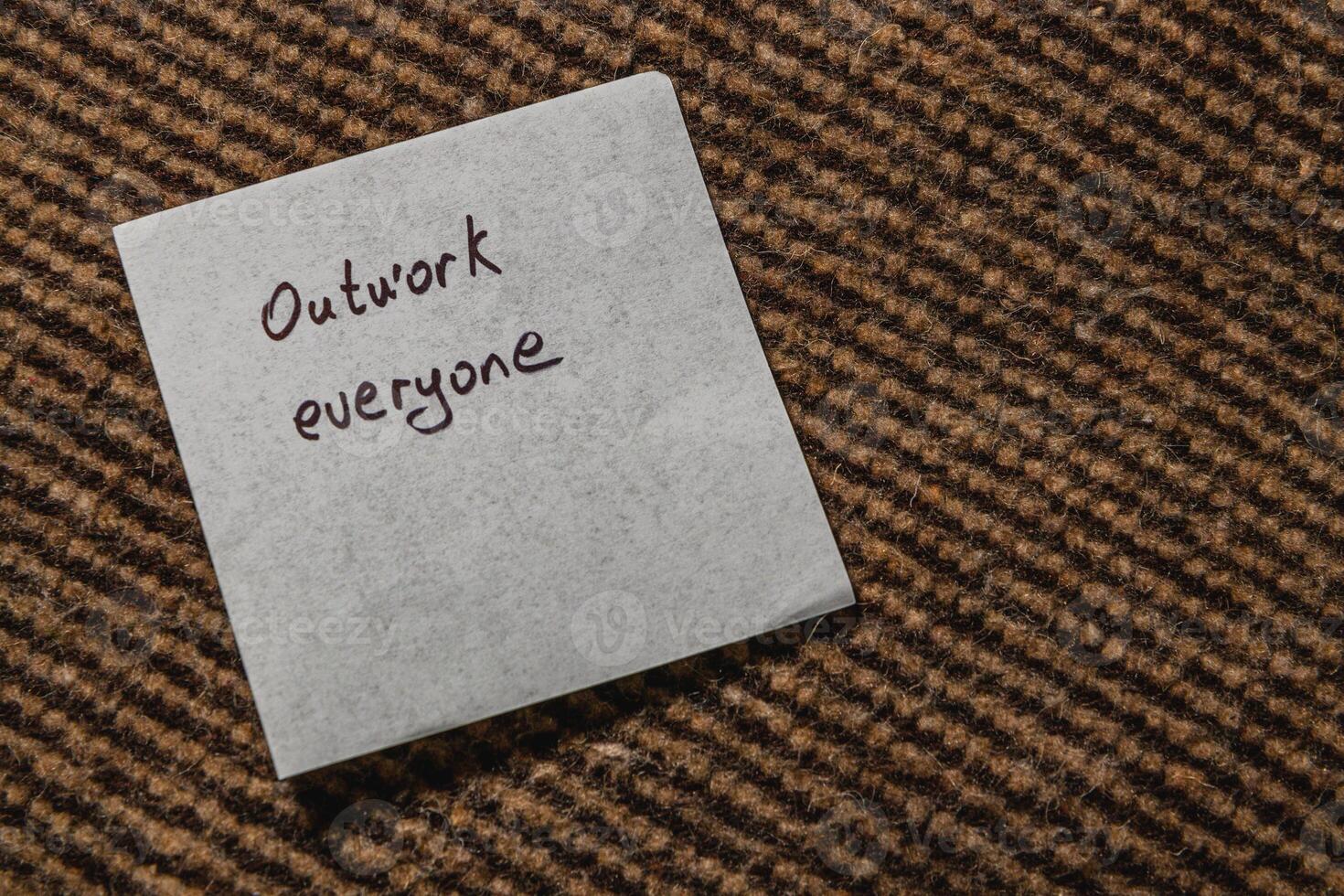 Reminder note encouraging teamwork and collaboration in a workspace photo