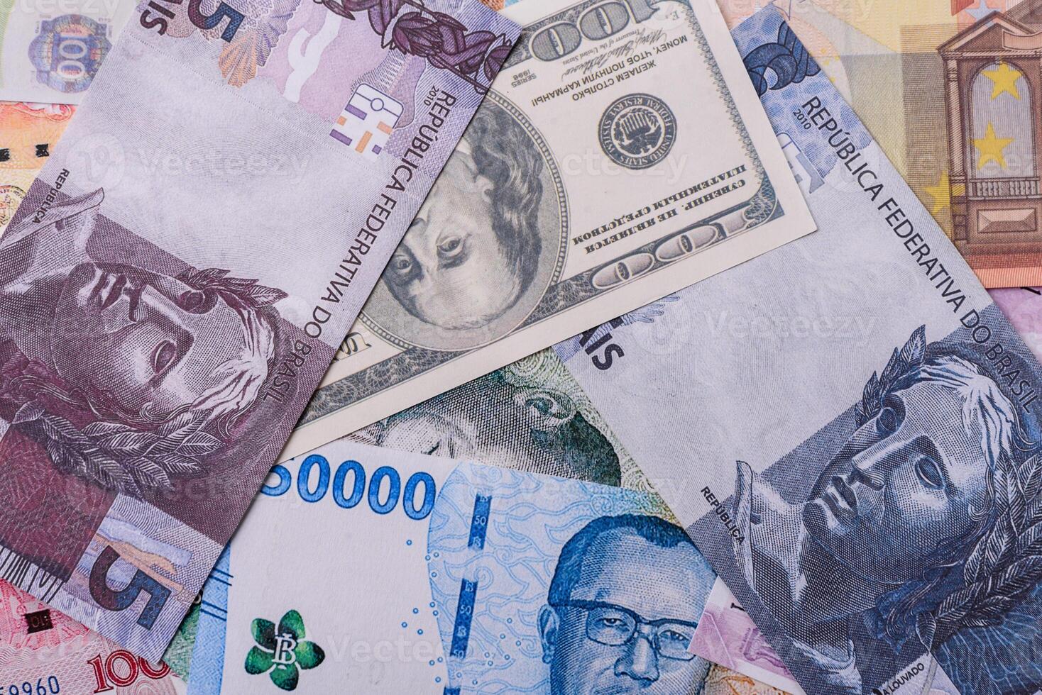 A background of paper banknotes of different currencies photo
