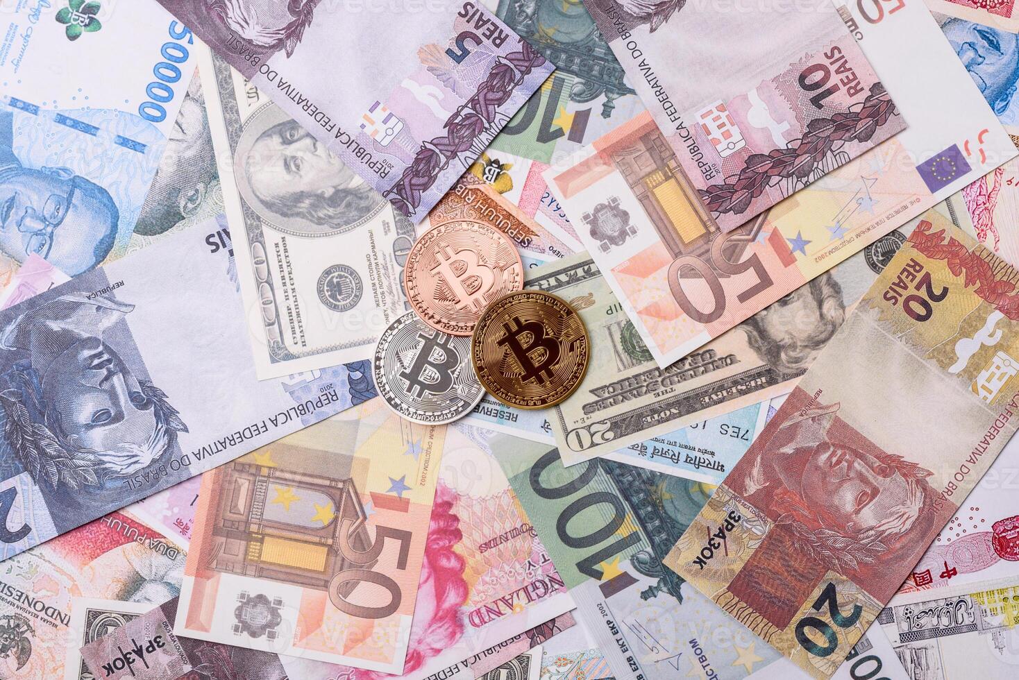 Round metal bitcoin on a background of paper banknotes photo
