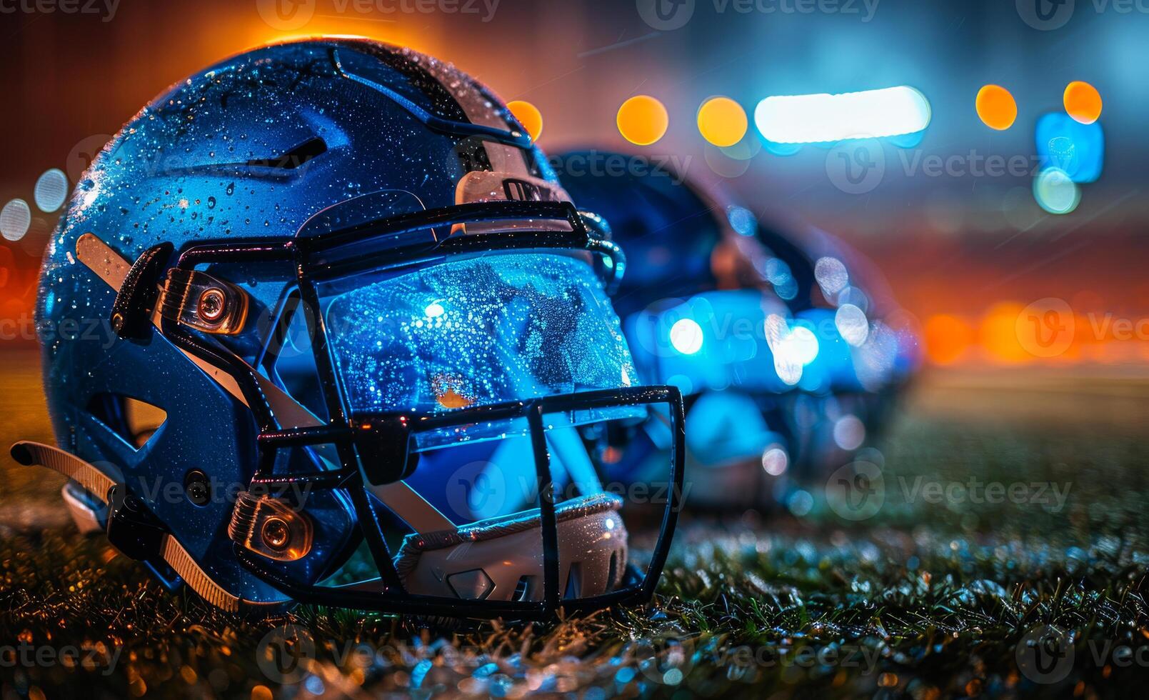 American football helmets on the field at night photo