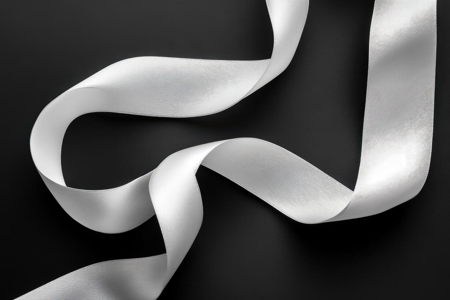 Elegant White Ribbon Curls on Black Background photo