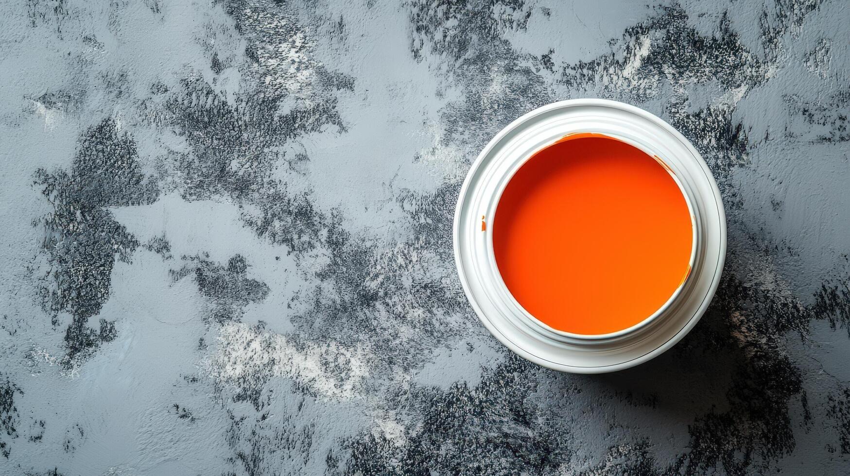 Orange Paint in a Can on a Gray Surface photo