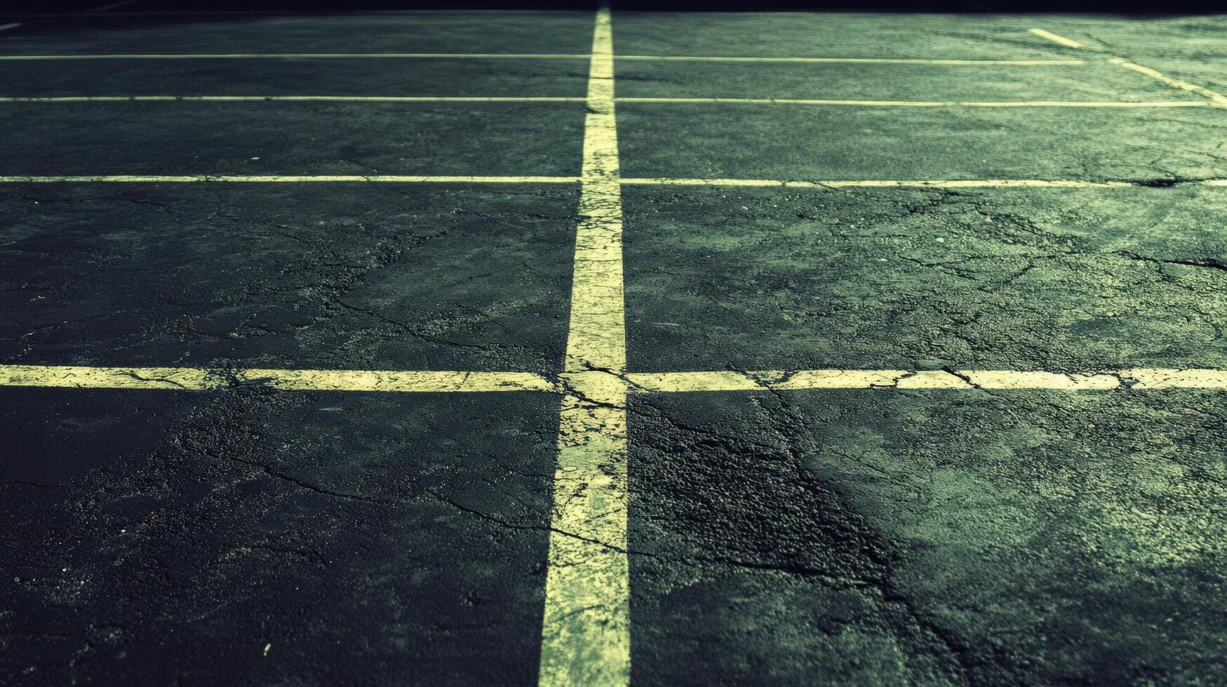 An empty parking lot with lines painted on it photo