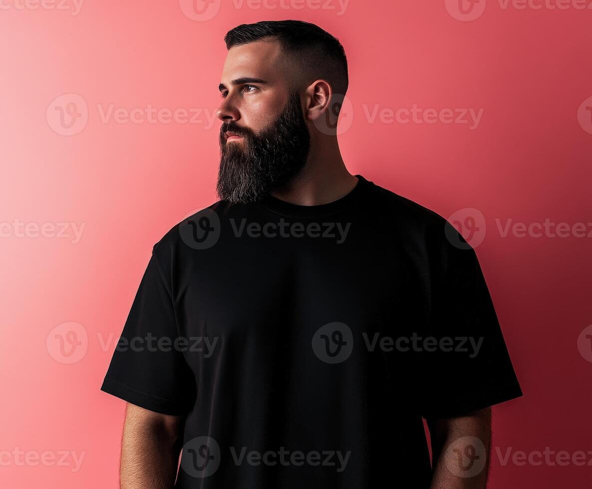 Man with beard poses against a pink background during a photoshoot photo