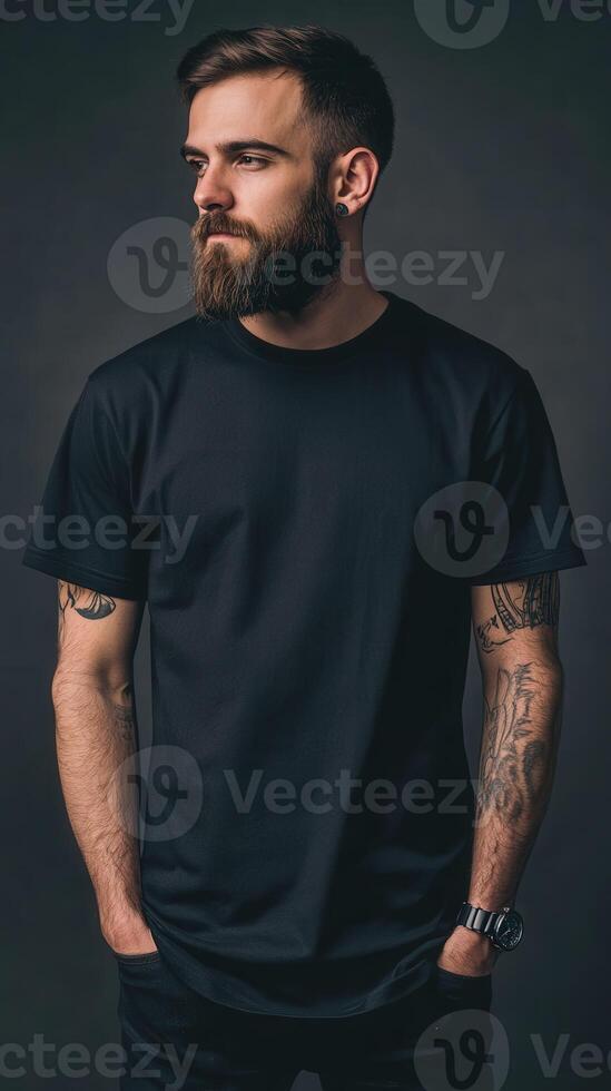 Man with tattoos poses in a studio against a dark backdrop photo