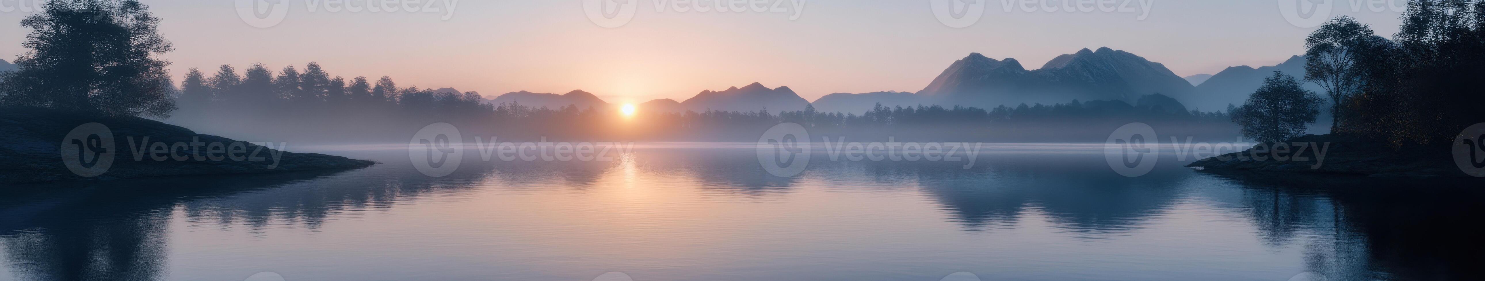 The sun rises over a lake in the mountains photo