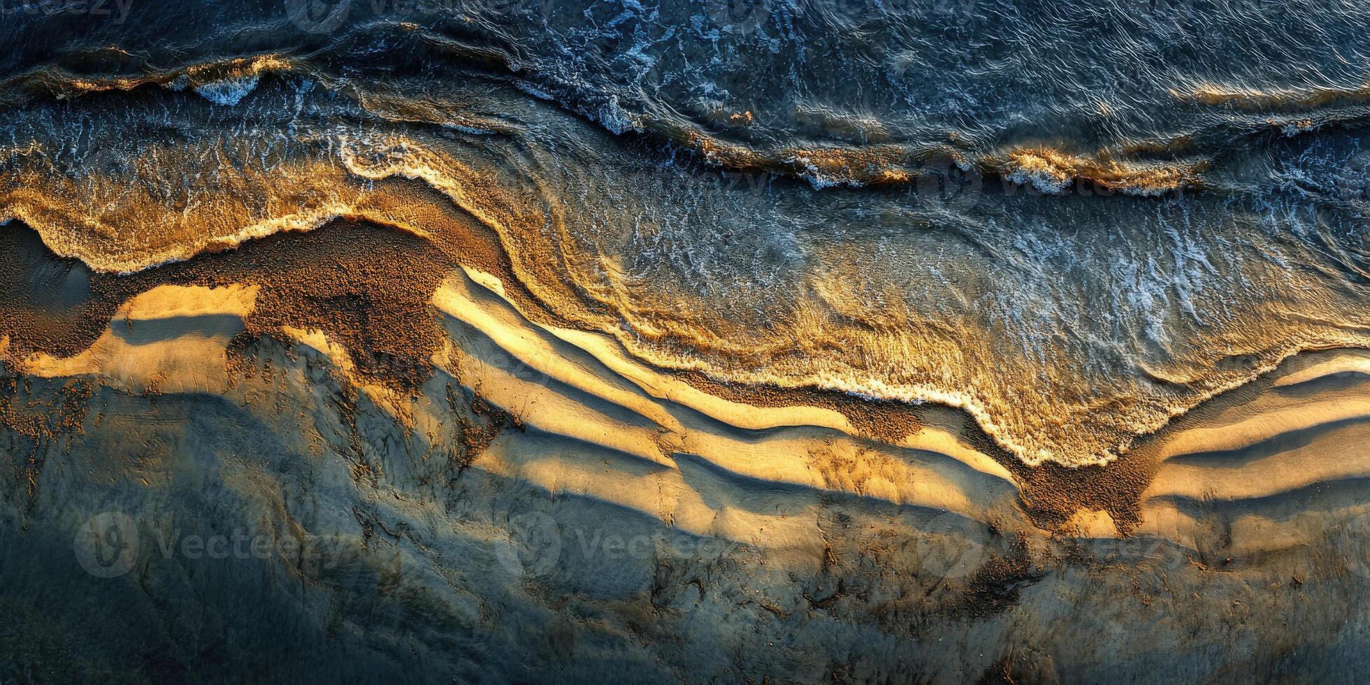 Waves crashing on a sandy shoreline at sunset photo