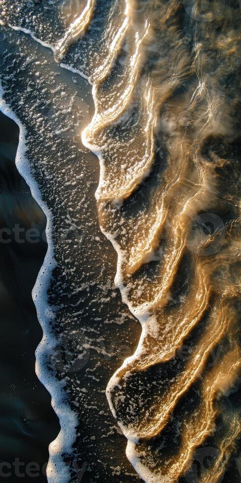 Calm shoreline waves create patterns at sunset photo