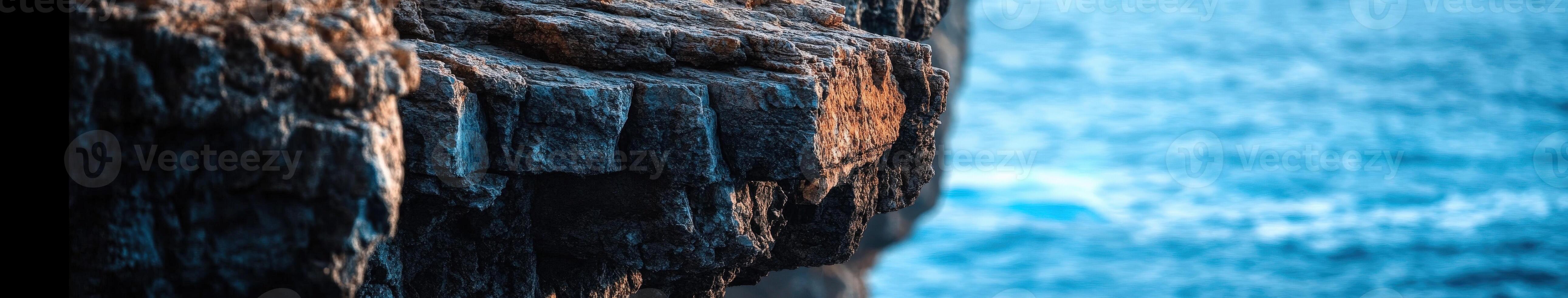 A rock cliff with water in the background photo