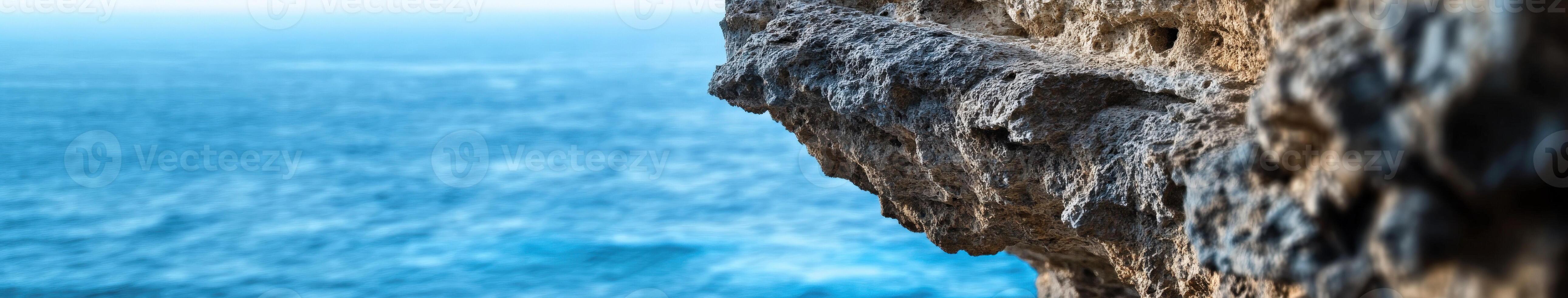 A person is standing on the edge of a cliff photo