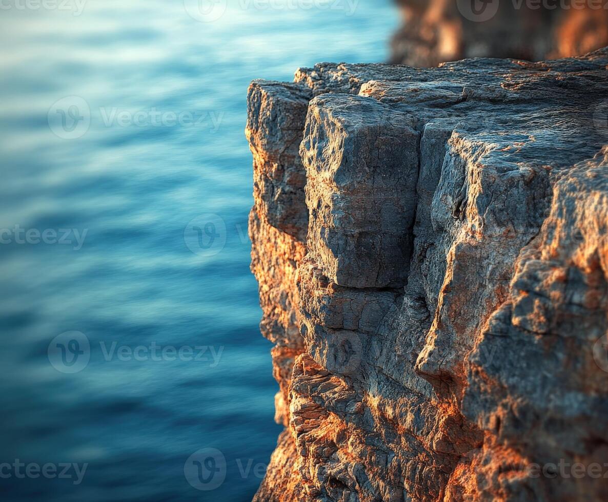 Rocky cliff overlooking calm water photo