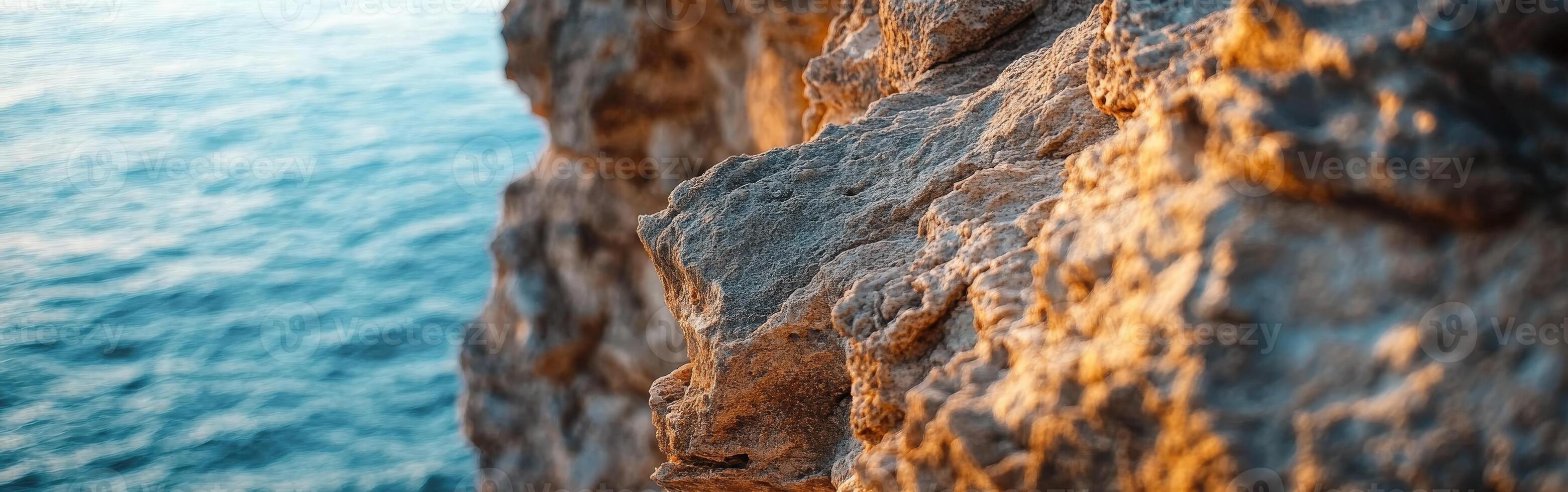 Waterfront rock texture at sunset photo
