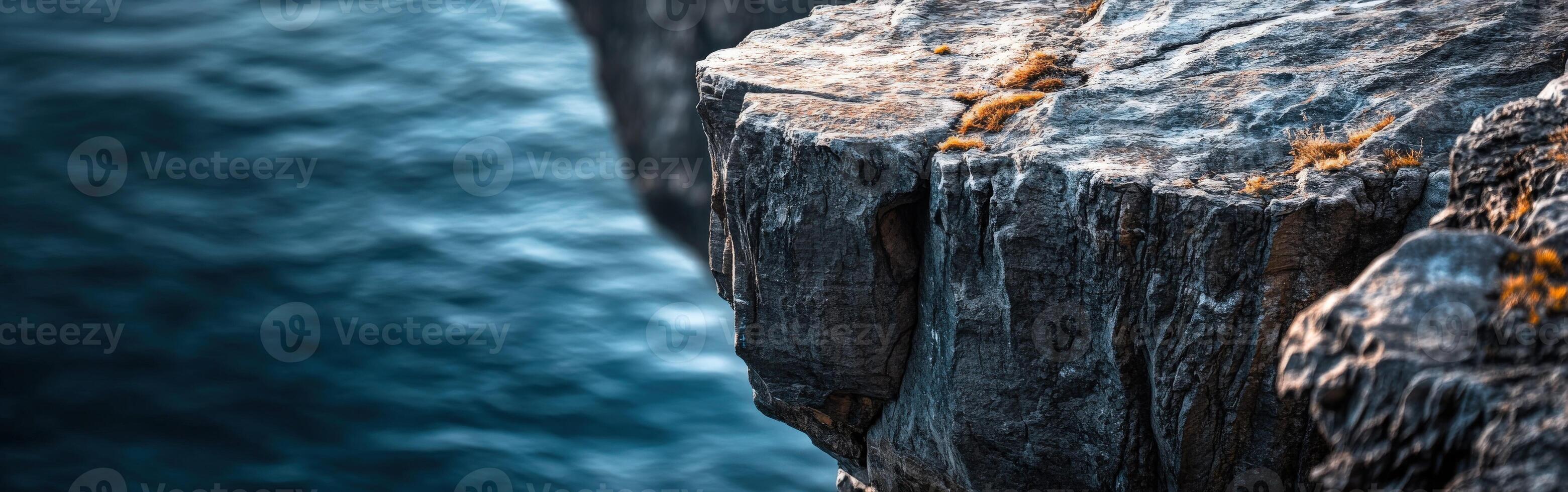 Rocky cliff near ocean waves photo