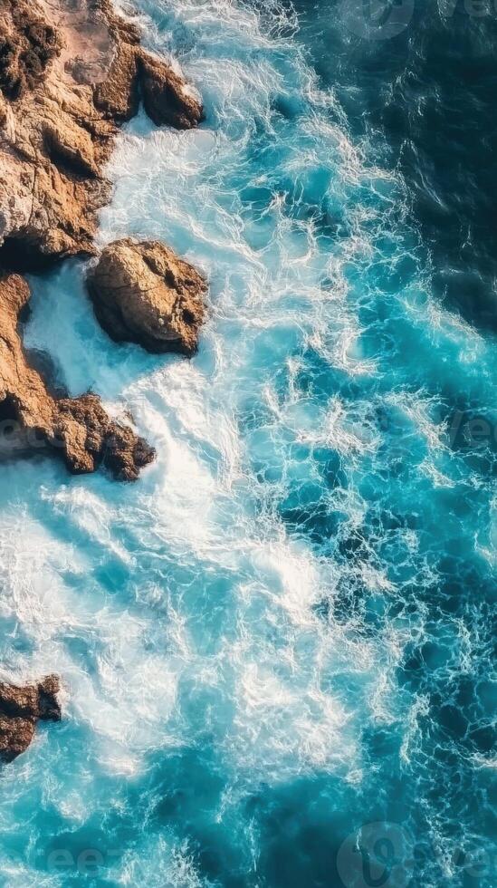 An aerial view of the ocean and rocks photo