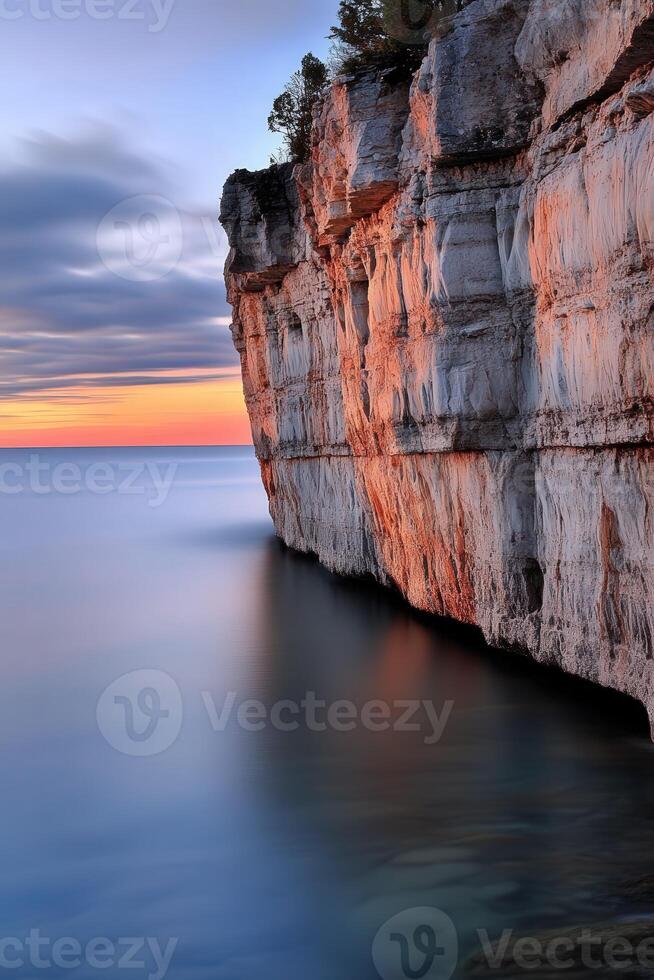 Sunset over the calm cliff edge photo