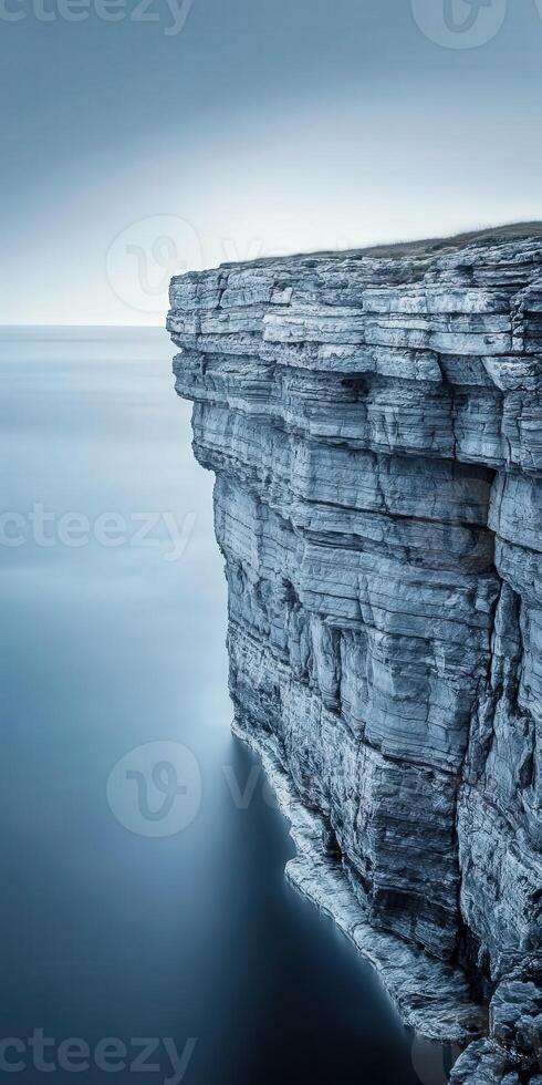 Cliffside view over calm waters photo