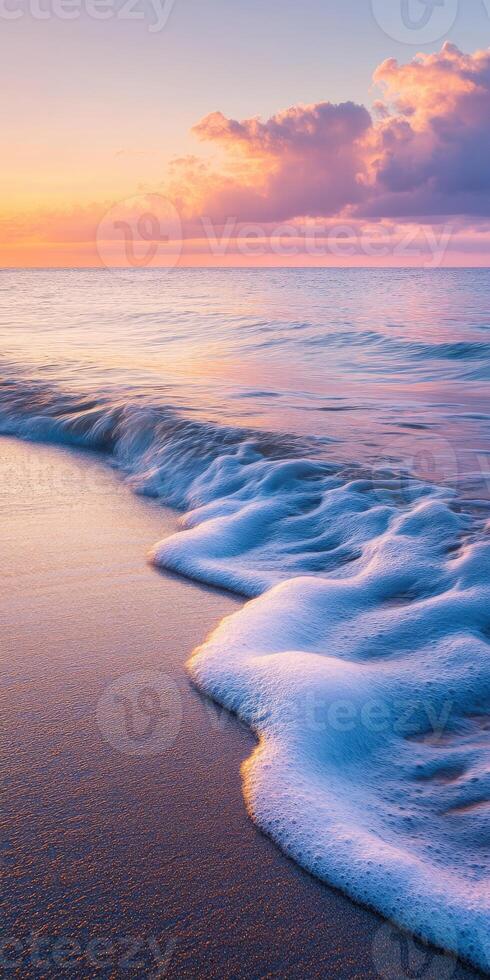 A beautiful sunset over the ocean with waves photo