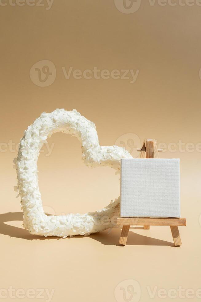 Empty white free space for advertisement template Symbol of love beautiful flower petals in heart shape in beige background. Creative concept of St Valentines day, weeding romantic date or anniversary. Copy space greeting card photo