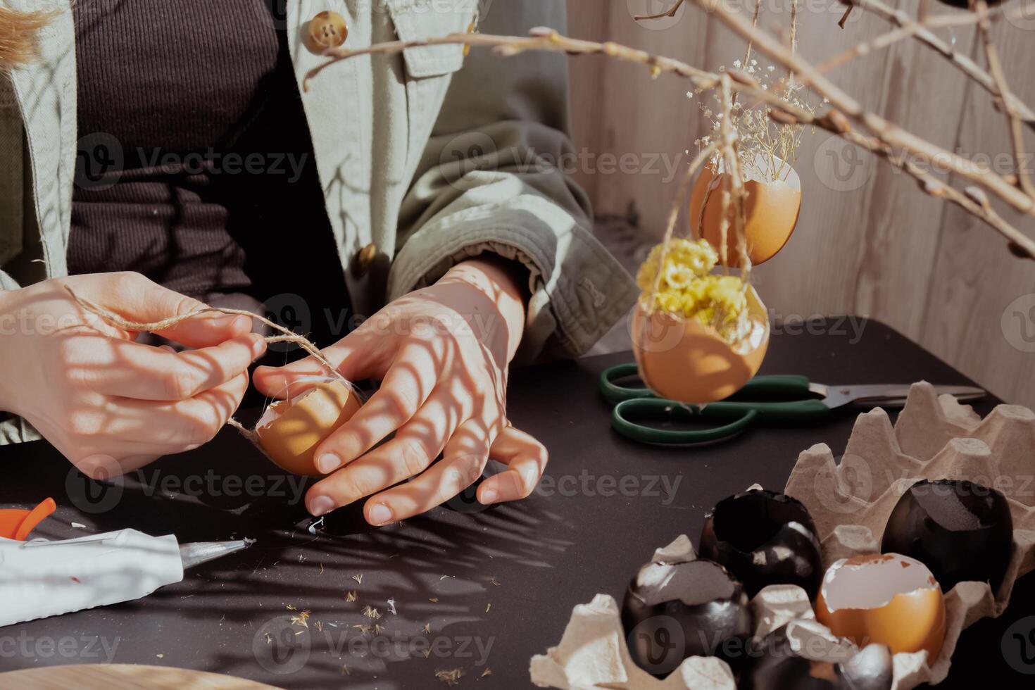 Unrecognizable woman creating Easter holiday decoration from egg shell. Diy do it yourself step by step instruction. Crafting preparation holiday photo