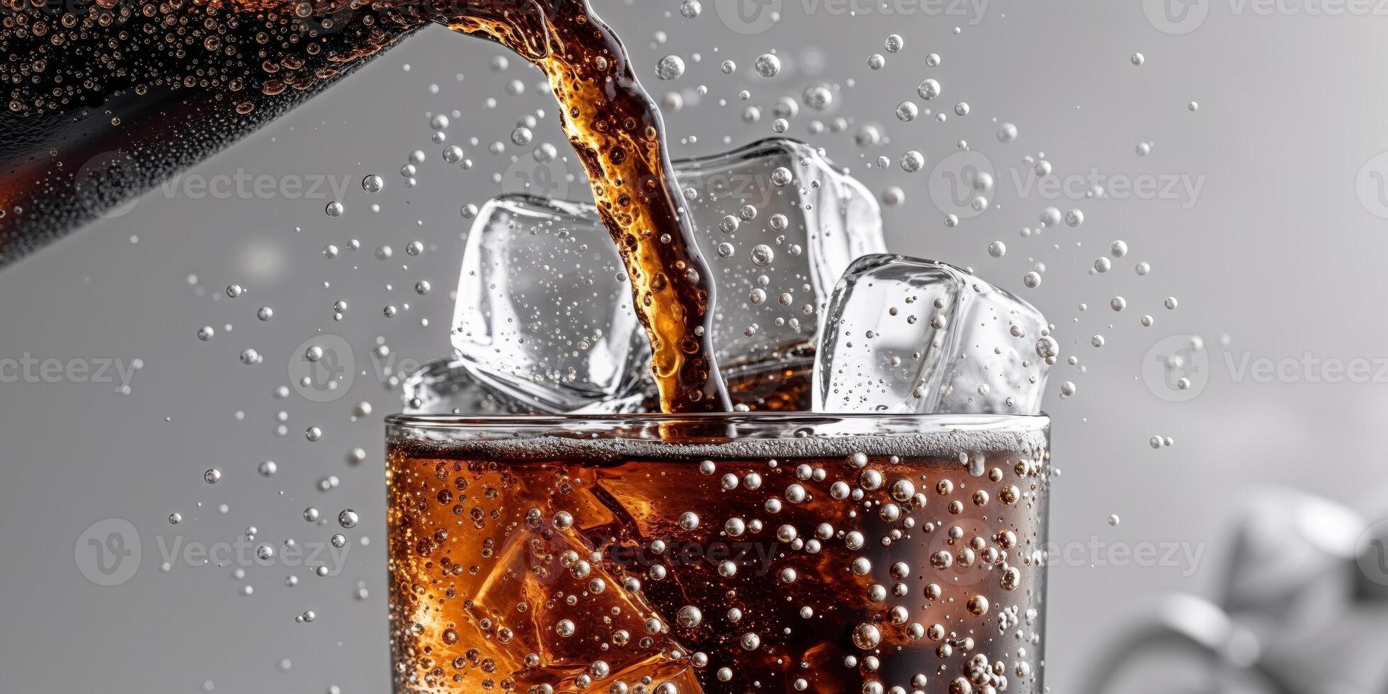 A glass of cola being poured into a glass photo