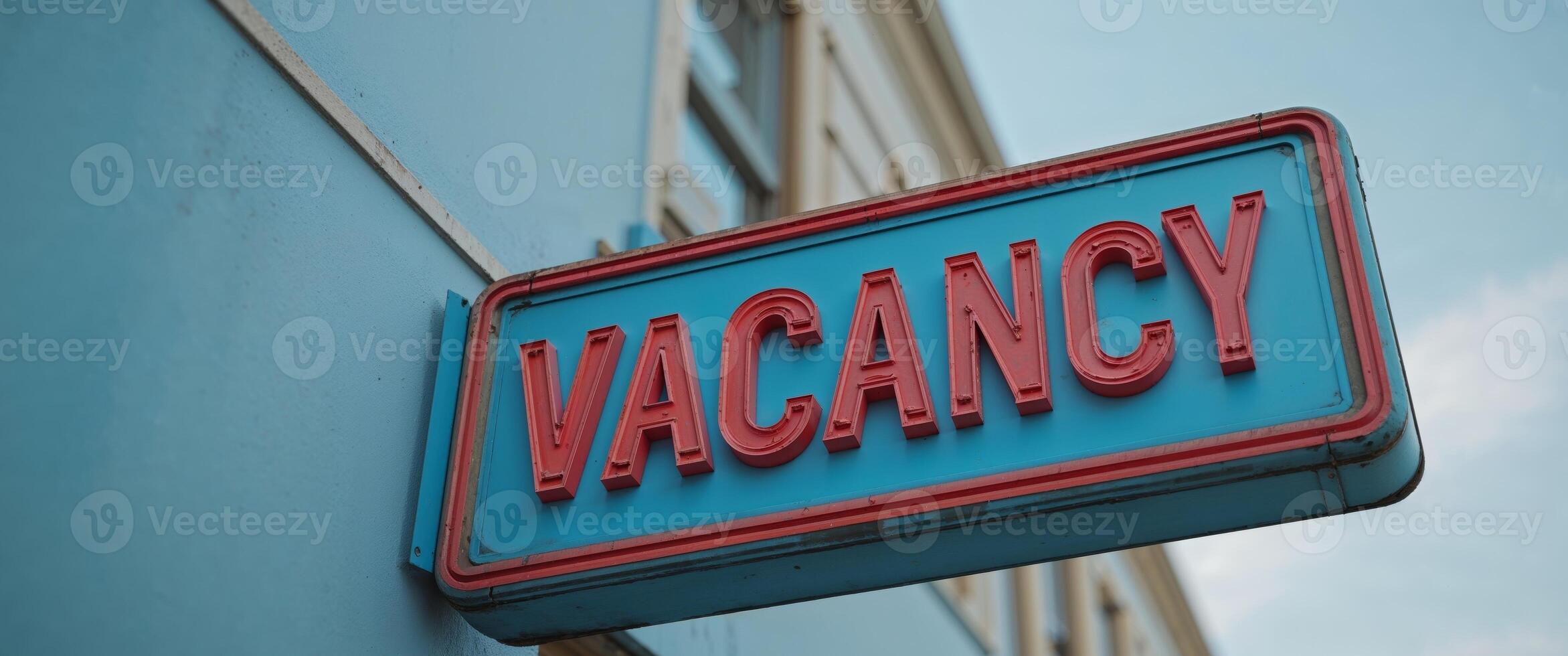 A blue and red sign that says vacancy photo