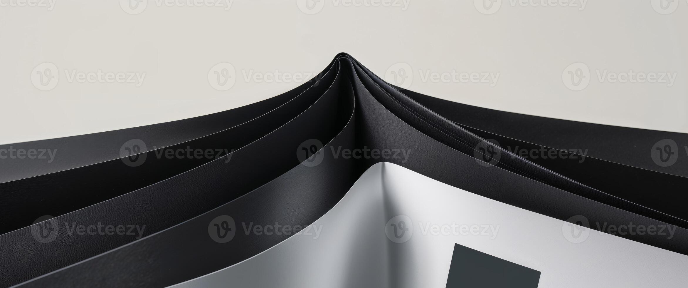 A black and white folded book with a white square photo