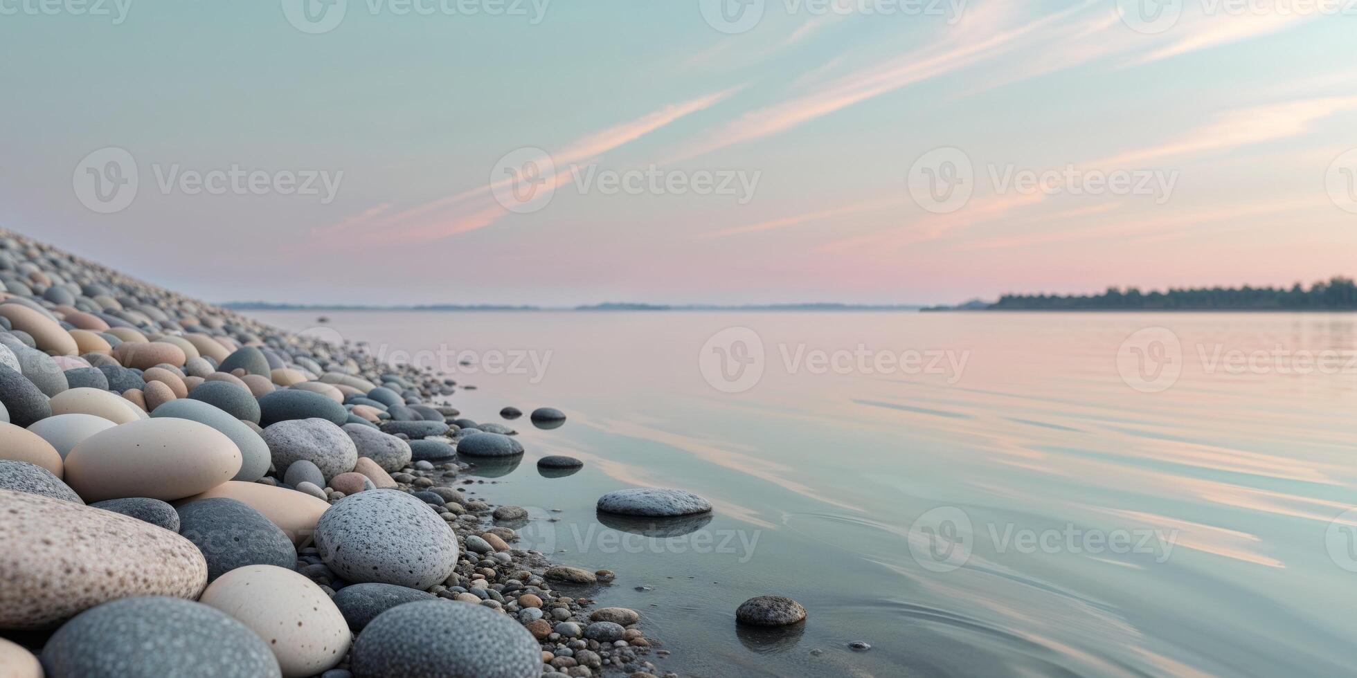 Serene lake shore with smooth stones and tranquil water reflecting a pastel sky. photo