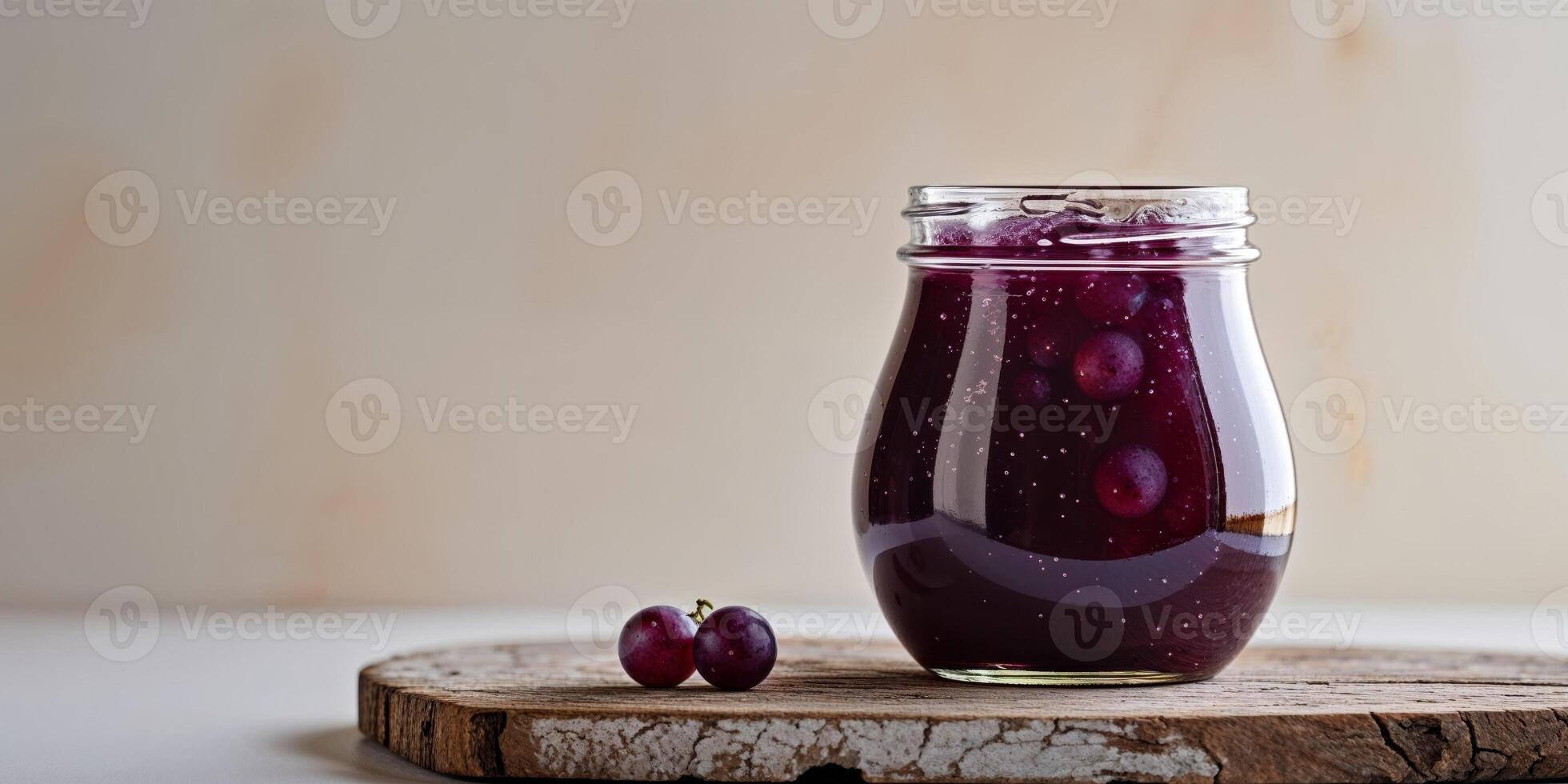 Dark Purple Grape Jam in Glass Jar on Wooden Board photo