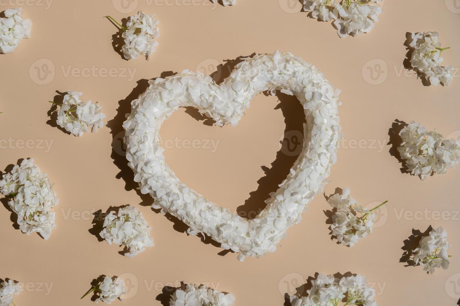 White lilac flowers heart shaped in pastel backdrop. Symbol of love floral arrangement. Spring concept idea Valentine's Day, weeding proposal postcard copy space for your text photo