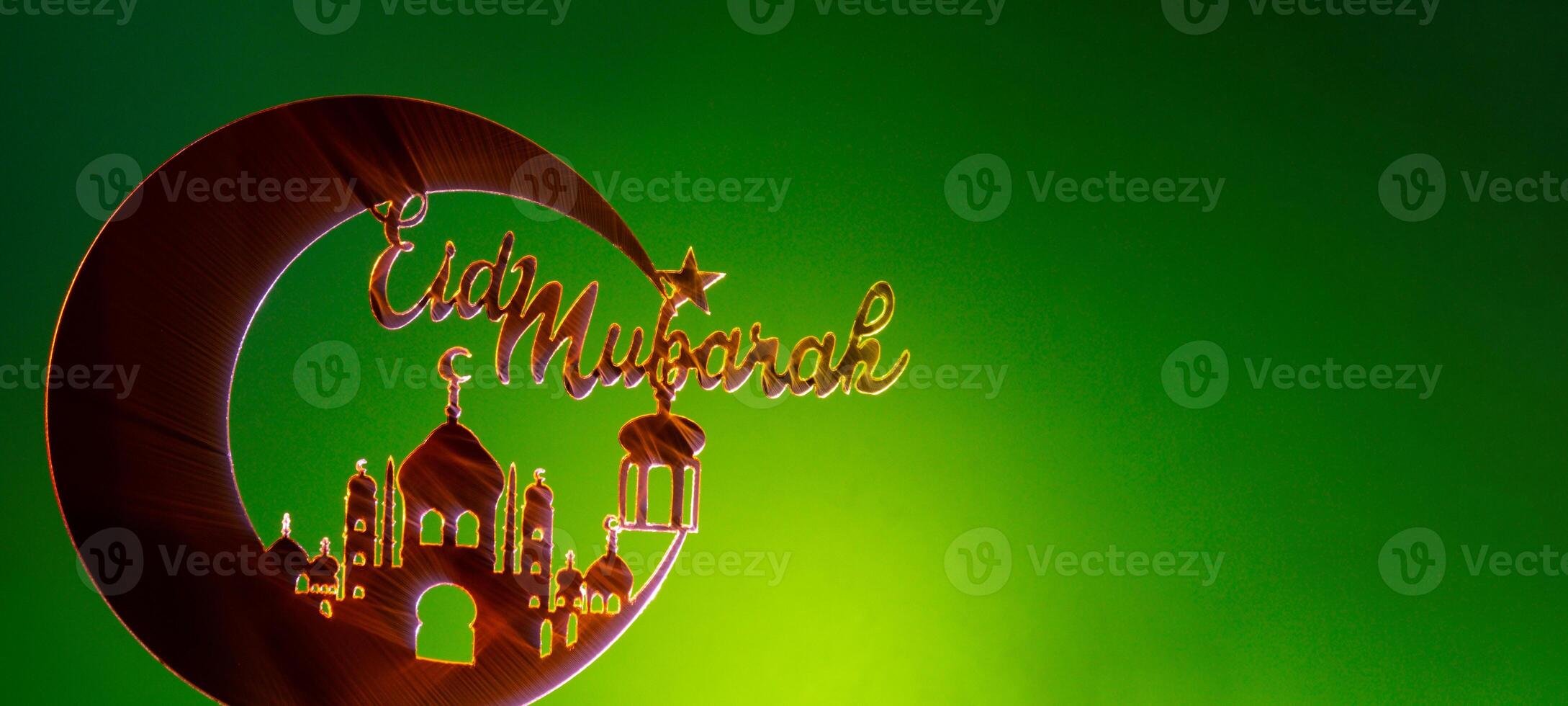 Crescent moon at top of mosque. Eid Mubarak text creative conceptual poster design for advertising branding. Mock up template for greeting card postcard. Ramadan Kareem background. Traditional muslim holiday. Copy space photo