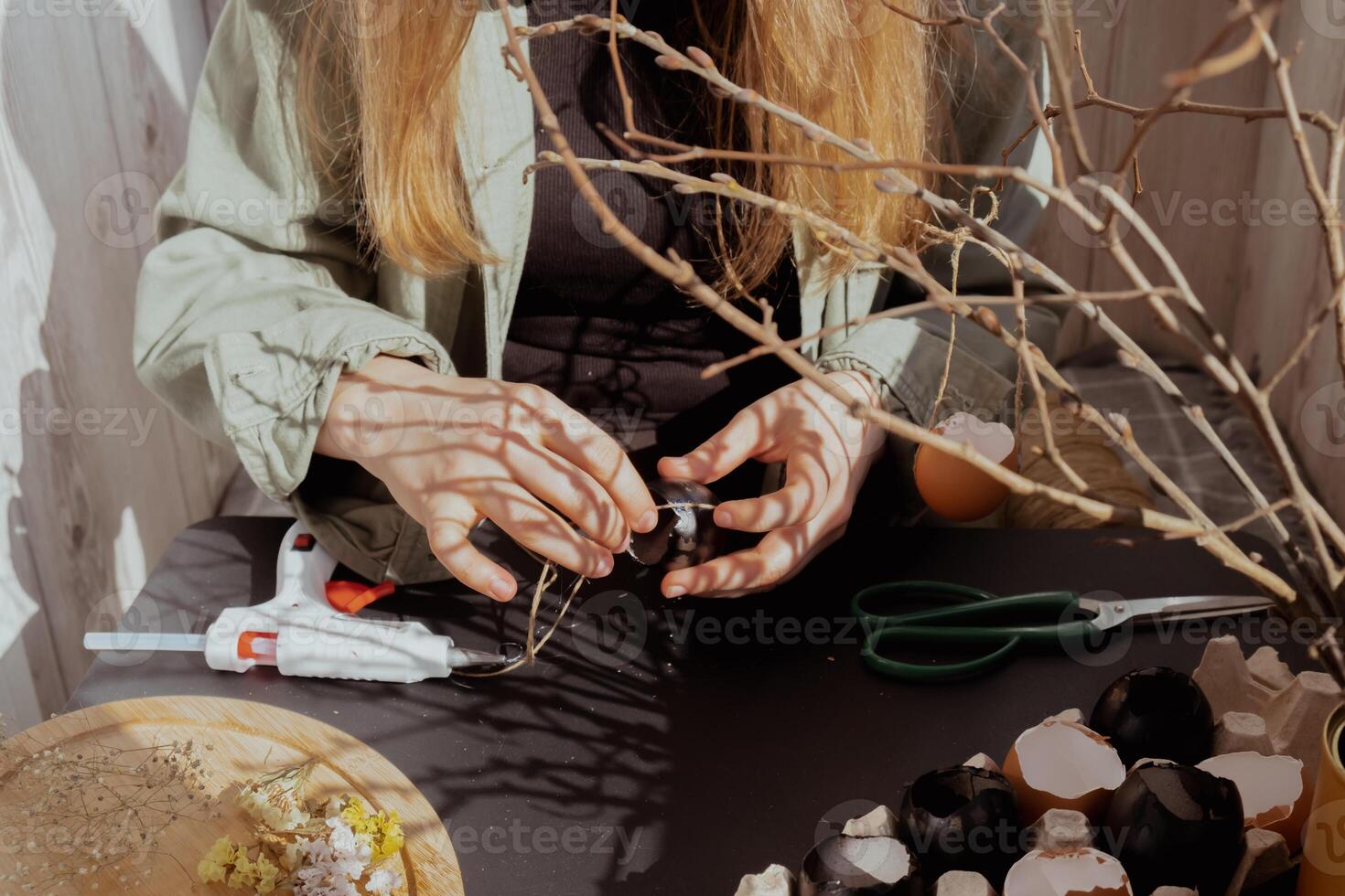 Unrecognizable woman creating Easter holiday decoration from egg shell. Diy do it yourself step by step instruction. Crafting preparation holiday photo