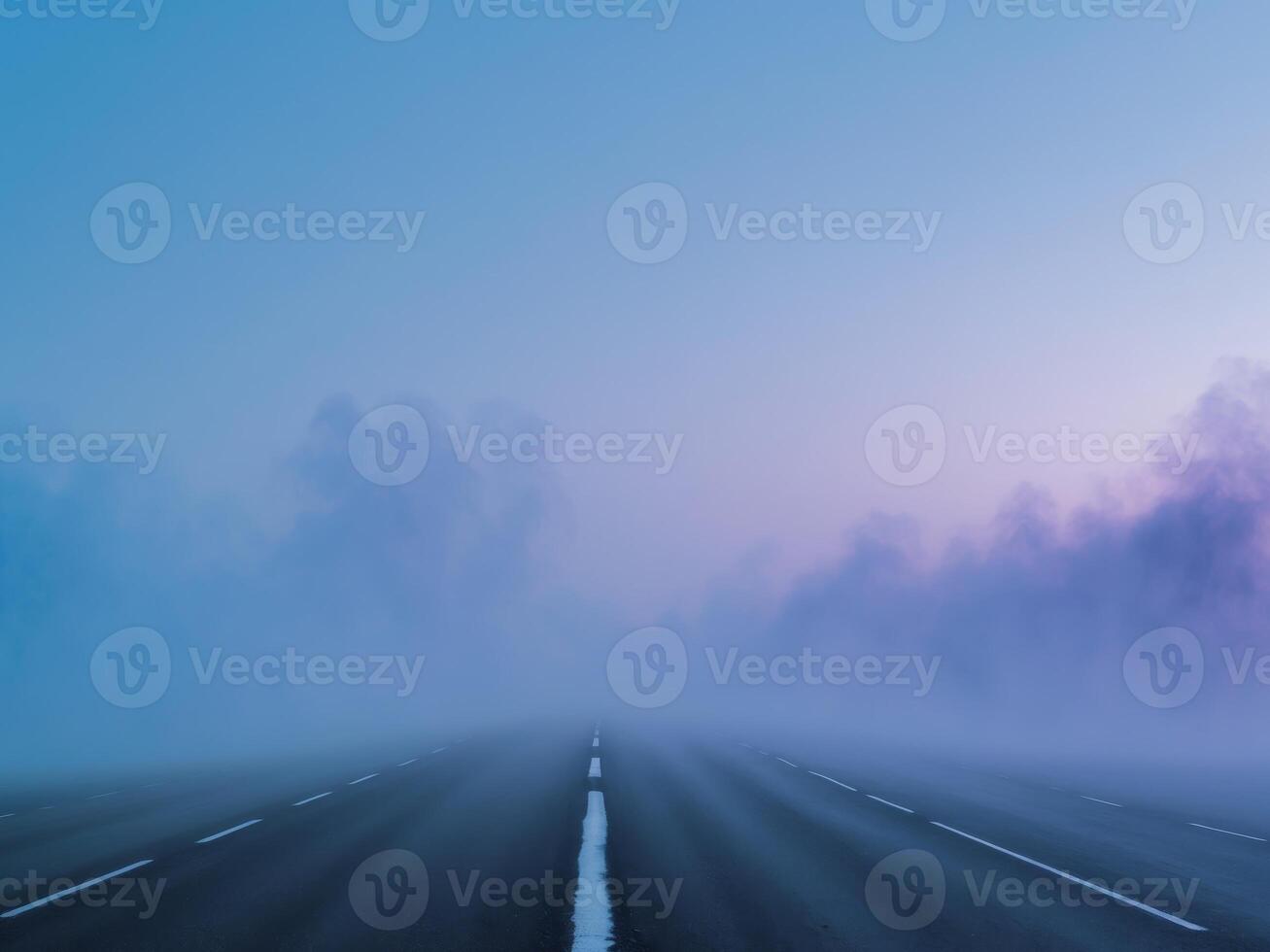 A road is covered in fog and trees photo