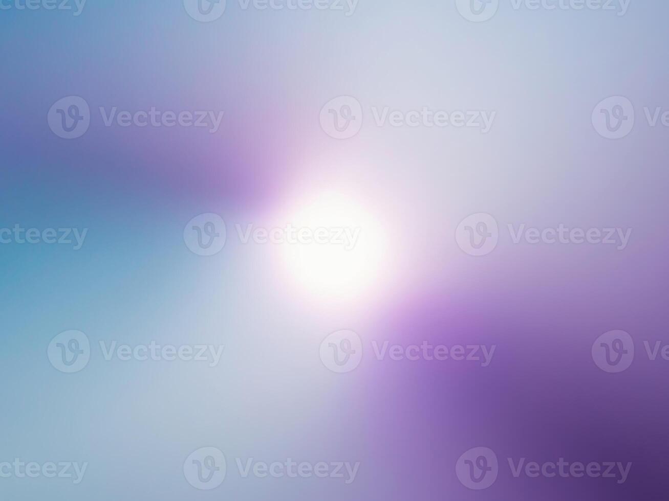A blurry image of a bright light in a blue and purple background photo