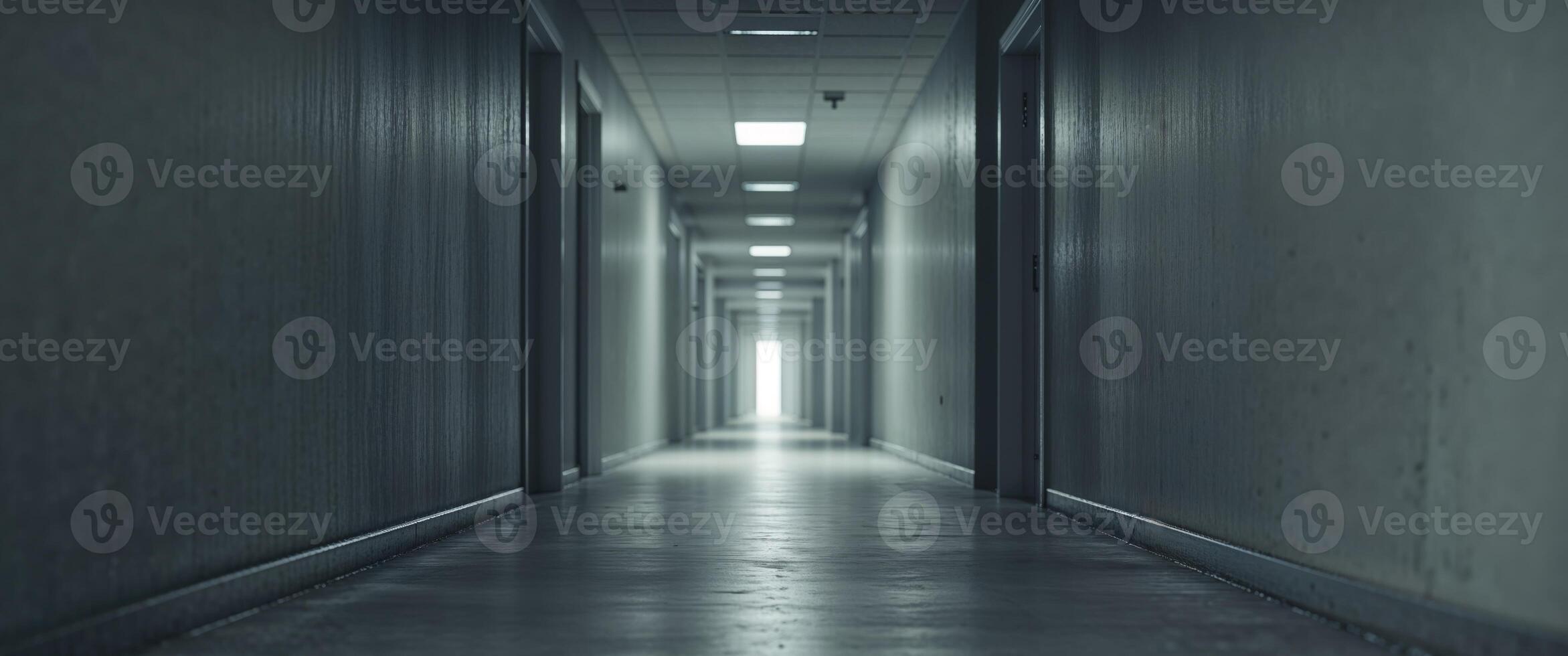 A long hallway with a light shining down the middle photo