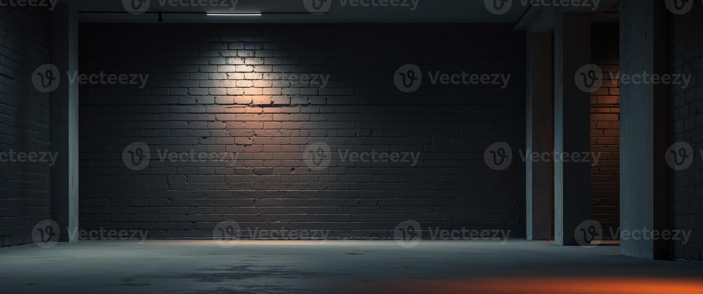 Dimly lit black brick wall with spotlight reflections in empty room photo