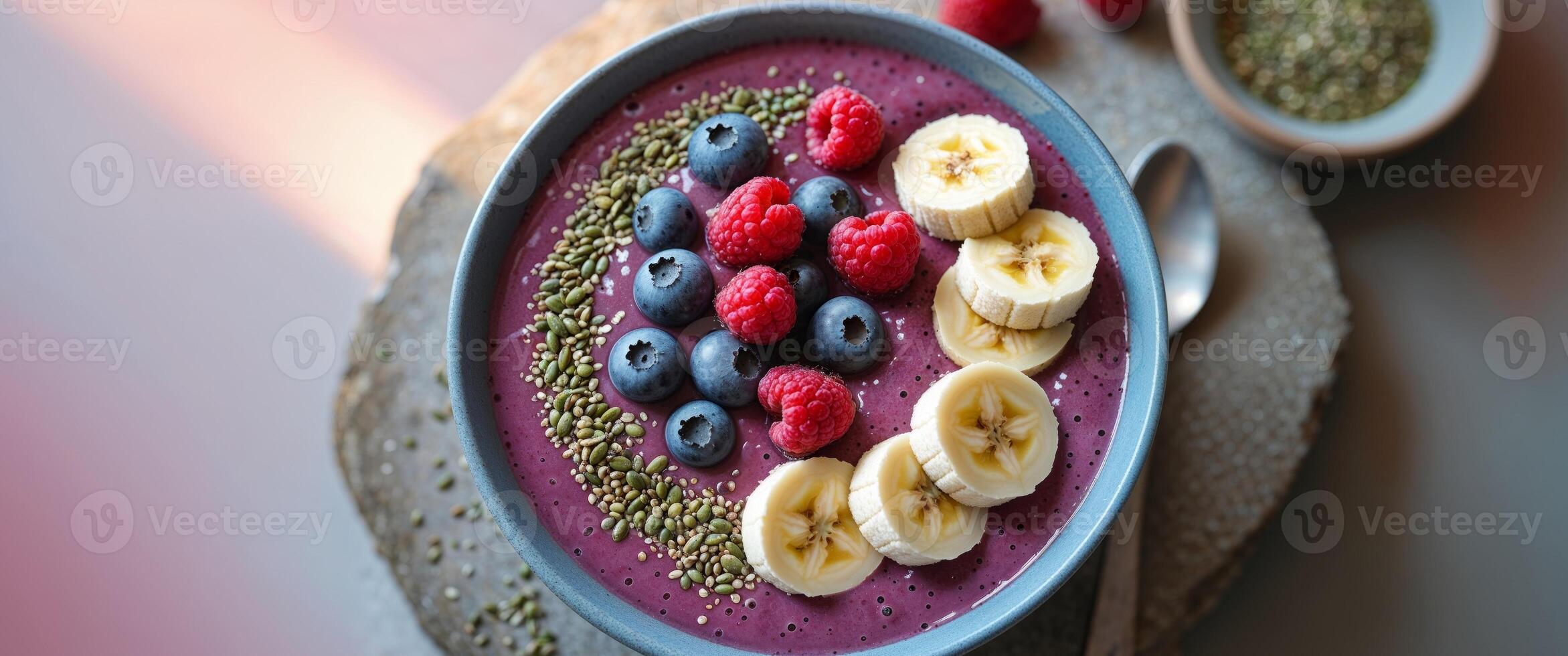 A bowl of smoothie with berries and bananas photo
