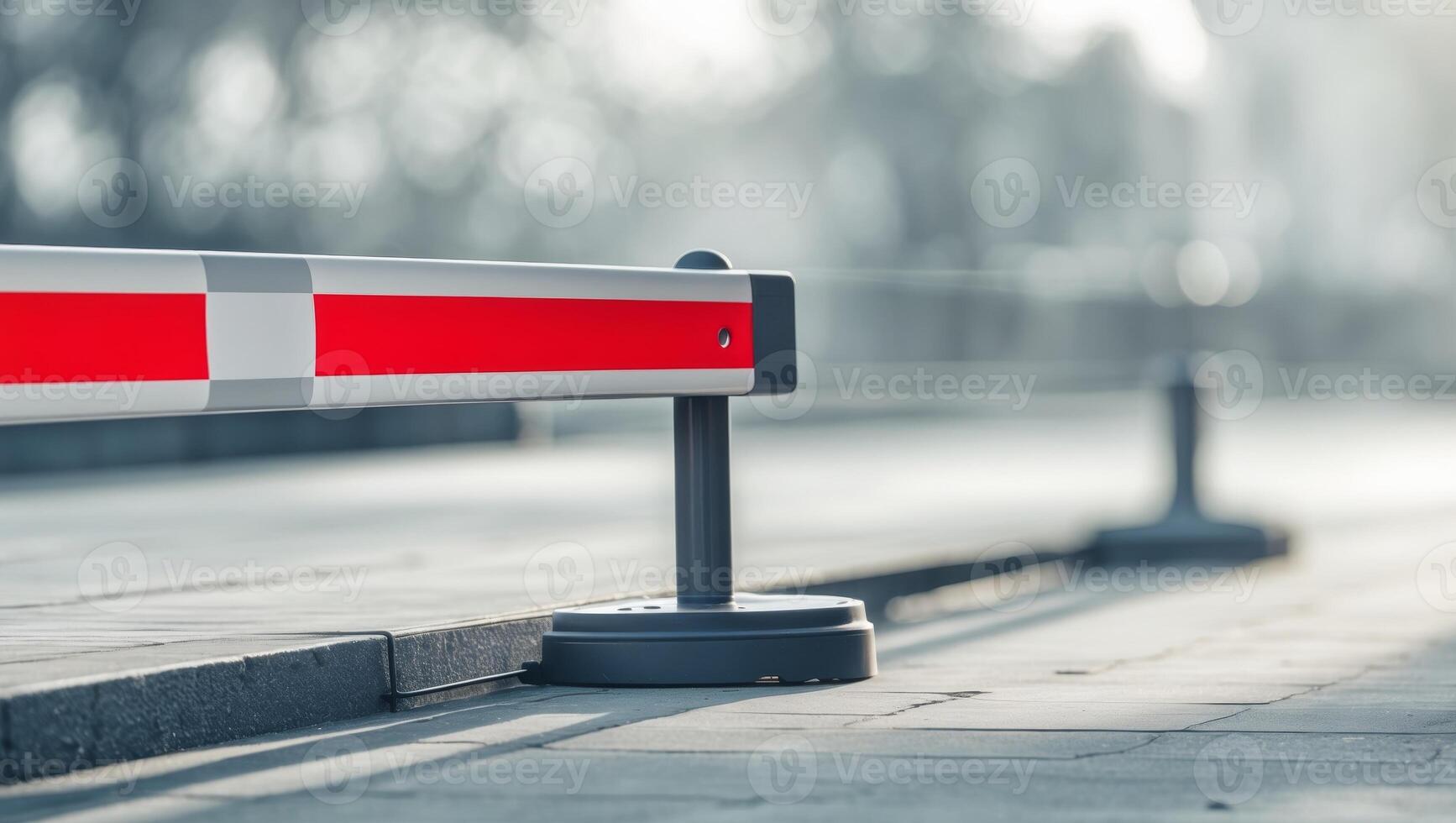 Traffic barrier with red and white stripes on footpath blurred background and ample copy space for transportation and safety concepts. photo