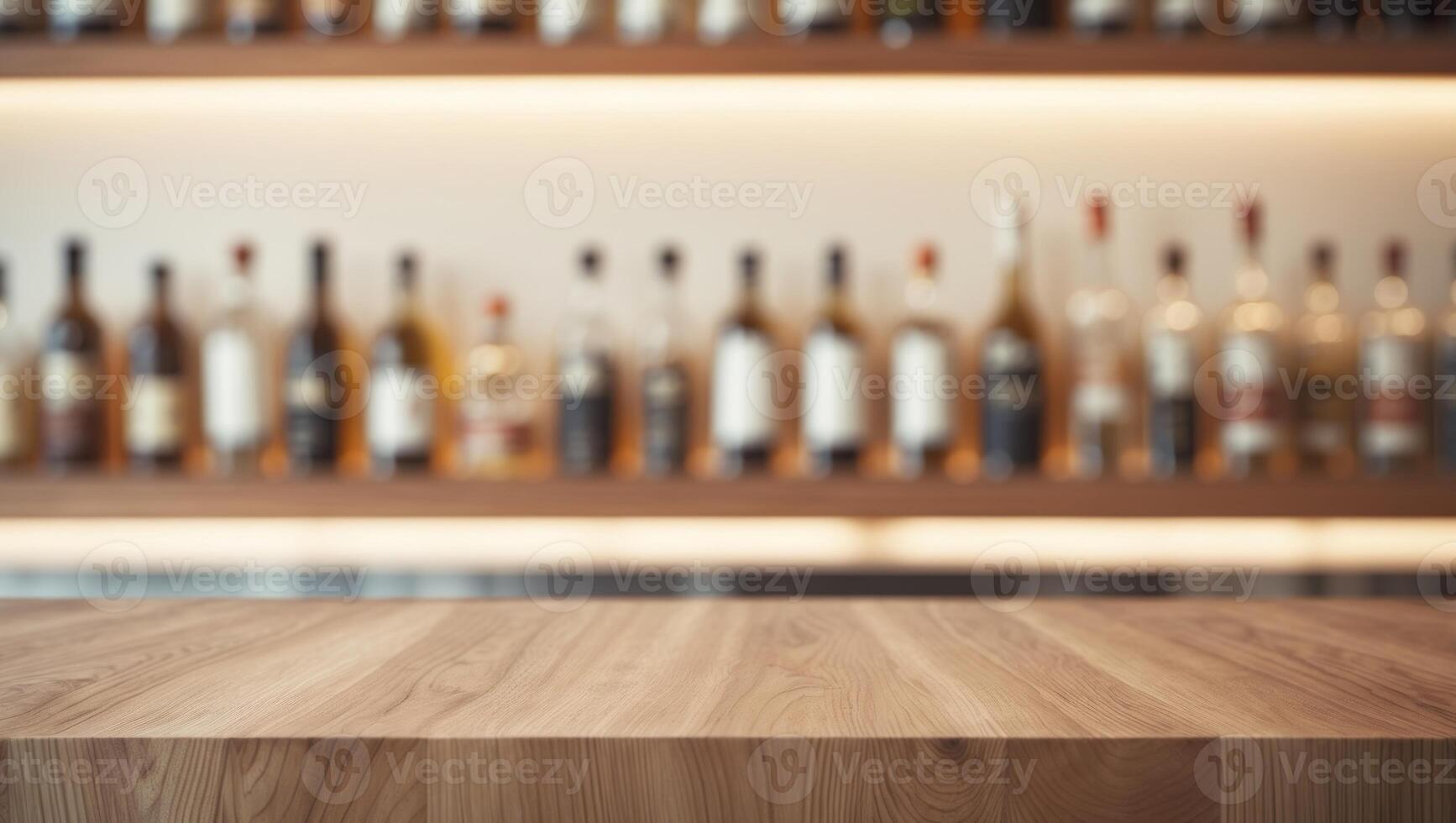 A wooden table in front of a row of bottles photo