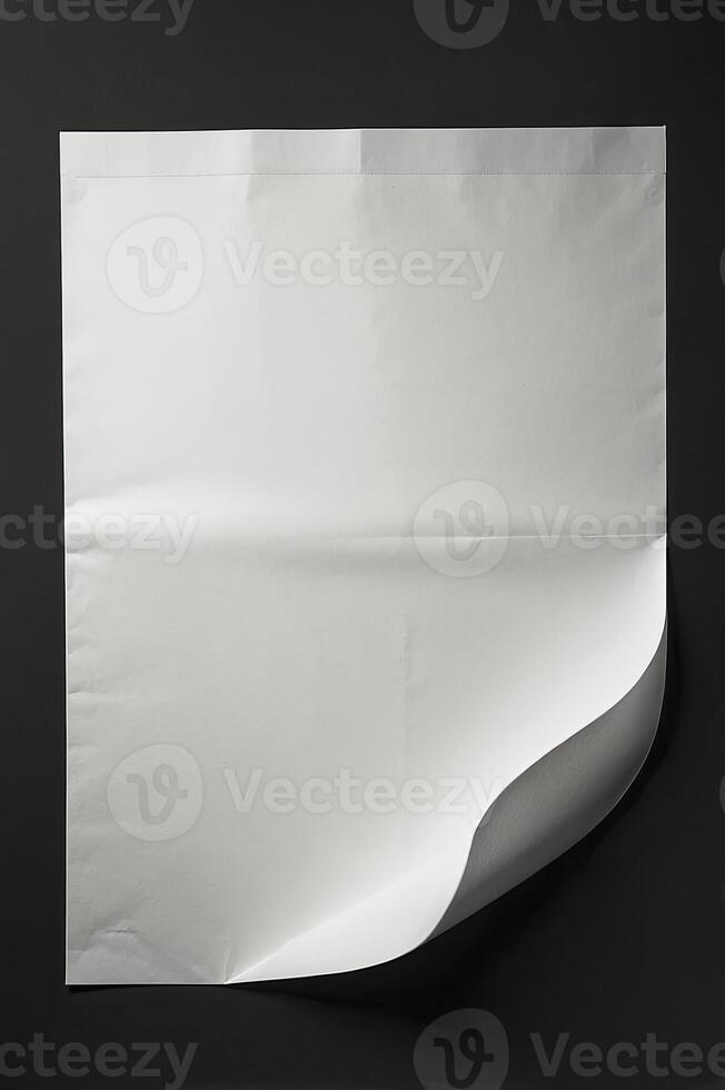Blank White Paper Sheet with Curled Corner on Dark Background Studio Shot photo
