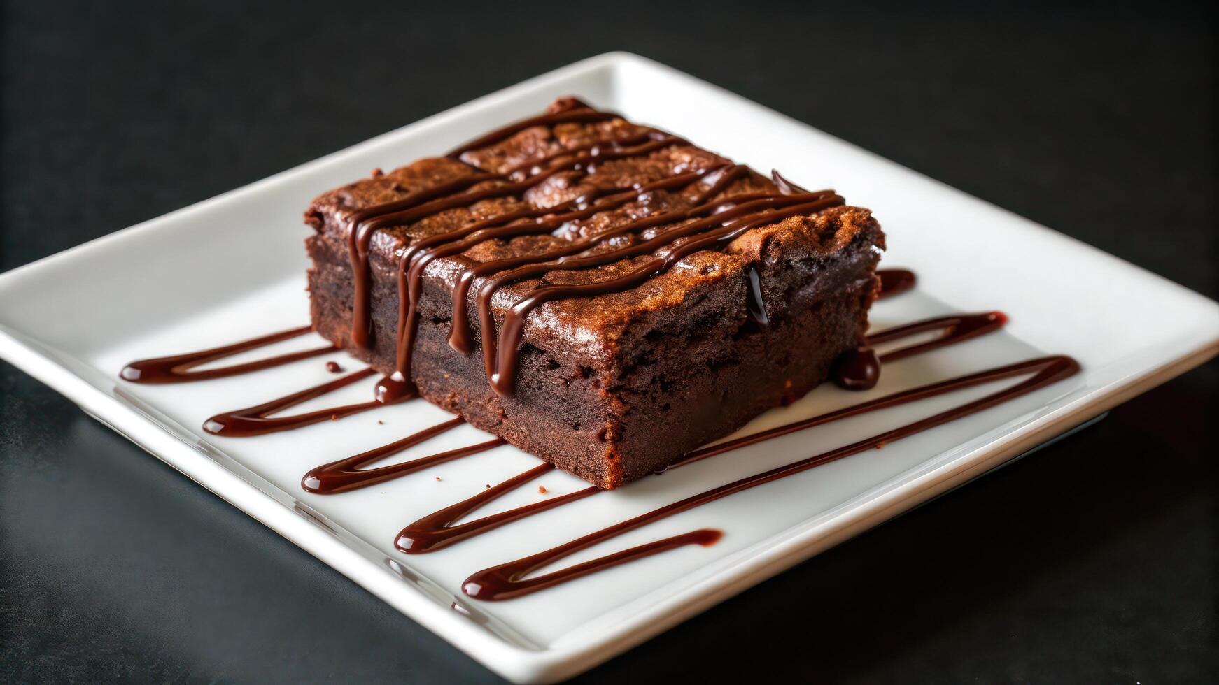 A square white plate topped with a brownie photo