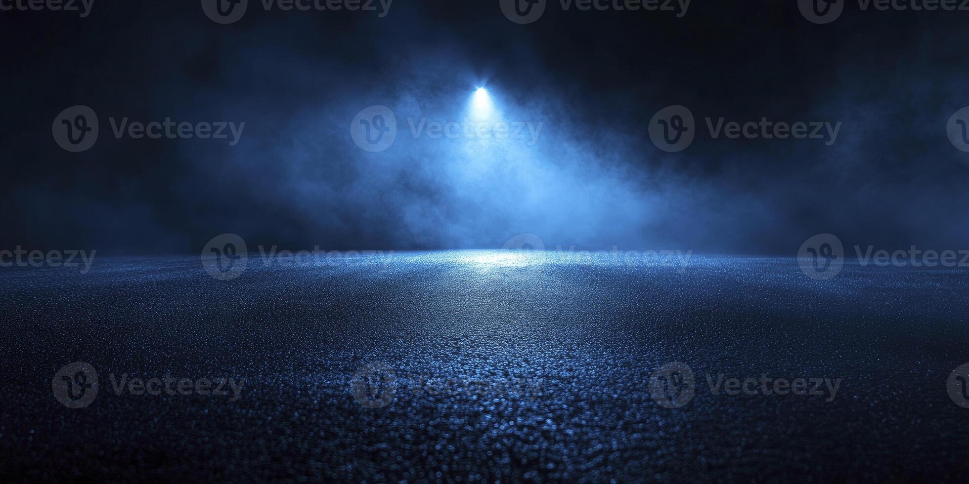 Spotlight Illuminating Dark Asphalt Surface with Smoky Blue Background photo