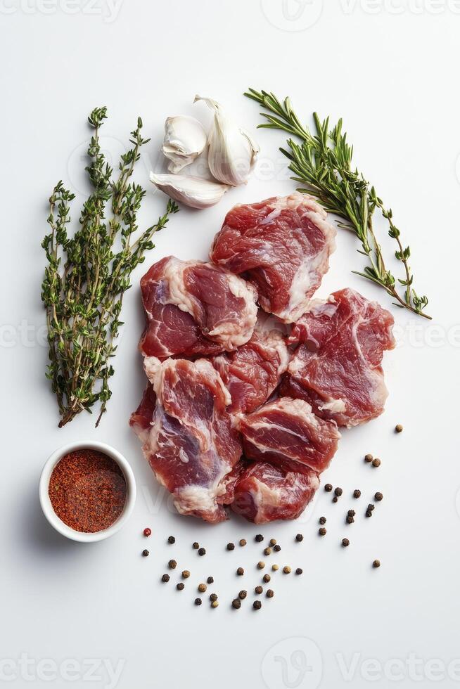 Raw Lamb Chops with Herbs and Spices on a White Background for Cooking photo