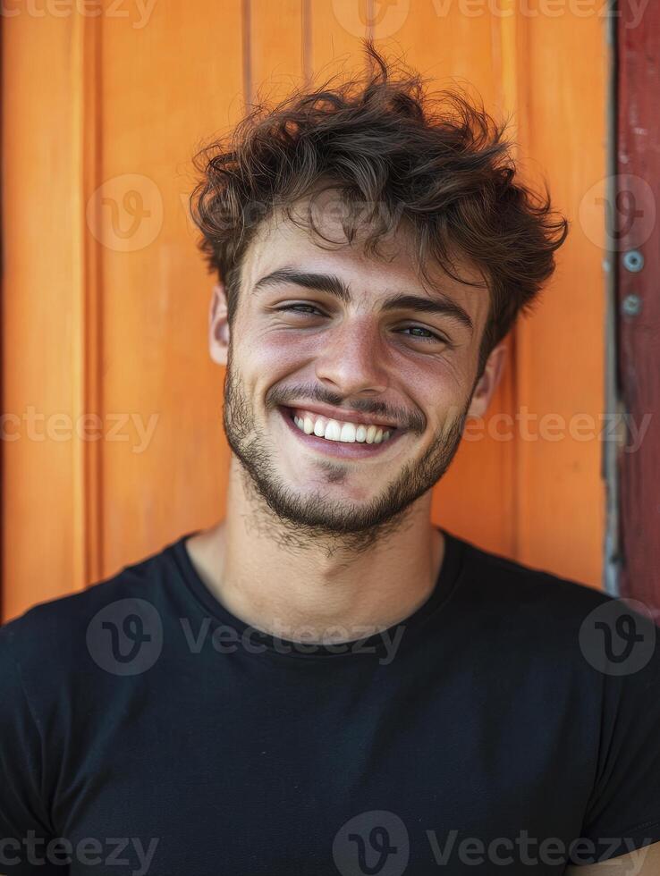 Smiling Young Man Portrait with Orange Door Background Happiness and Positive Vibes photo