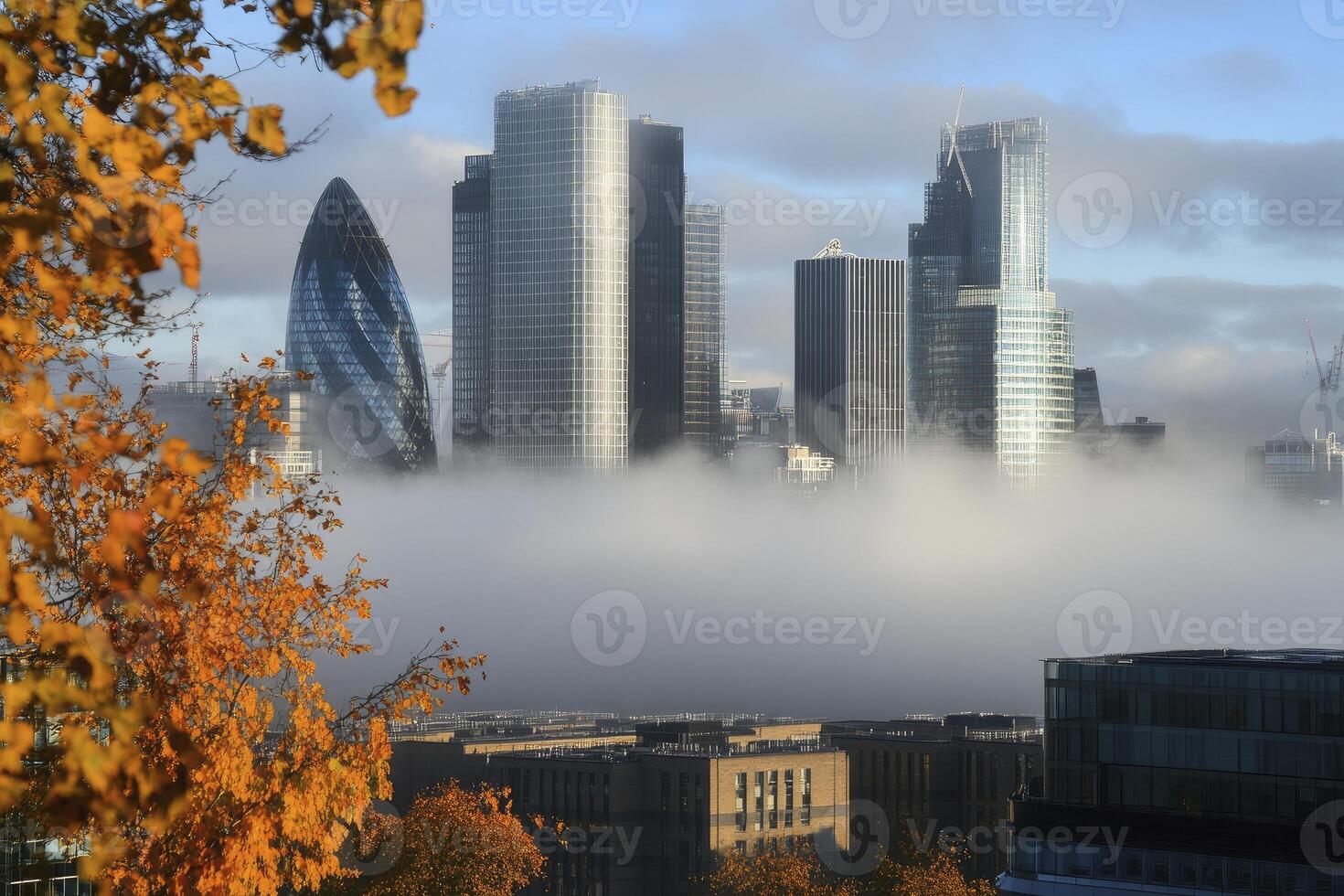 Fog Enveloping London Skyline View with Autumn Tree in Foreground photo